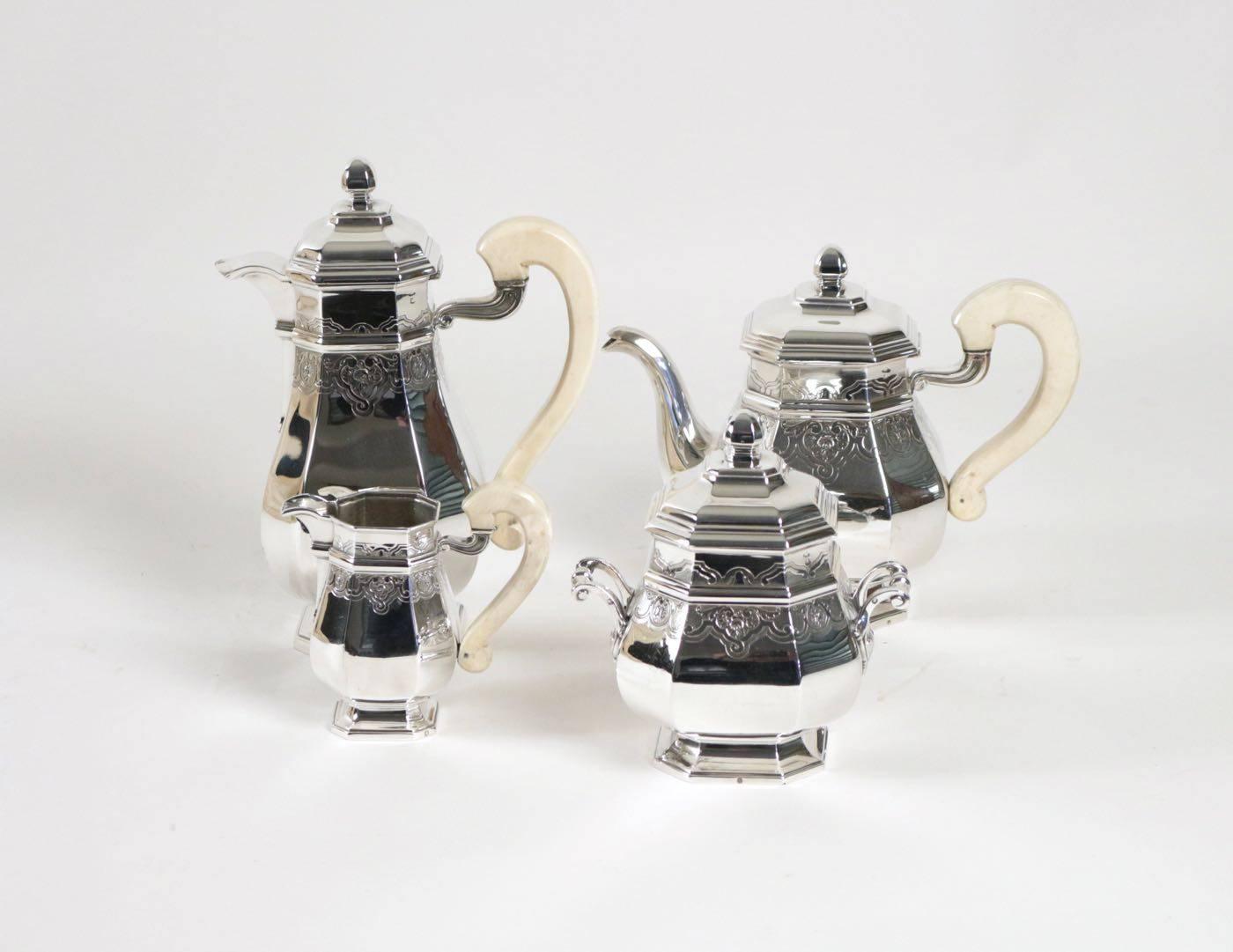 A magnificent, fine and impressive antique French 950 standard silver four piece tea and coffee set and coffee service with pattern with decoration. The set includes a coffee pot, a teapot, a covered sugar pot and a creamer.
Ivory handle for each