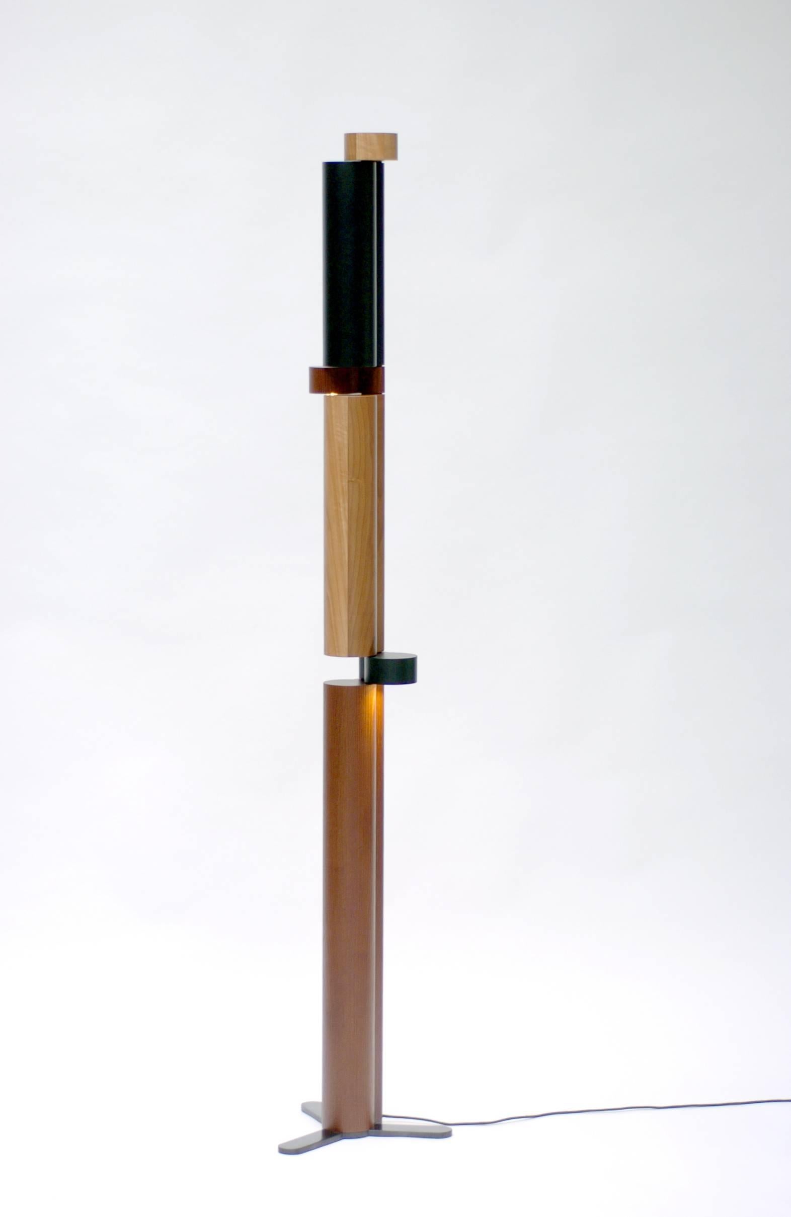 Floor lamp made with three different types of wood (acacie, walnut, tinted beech) by French designer Thomas Lemut.