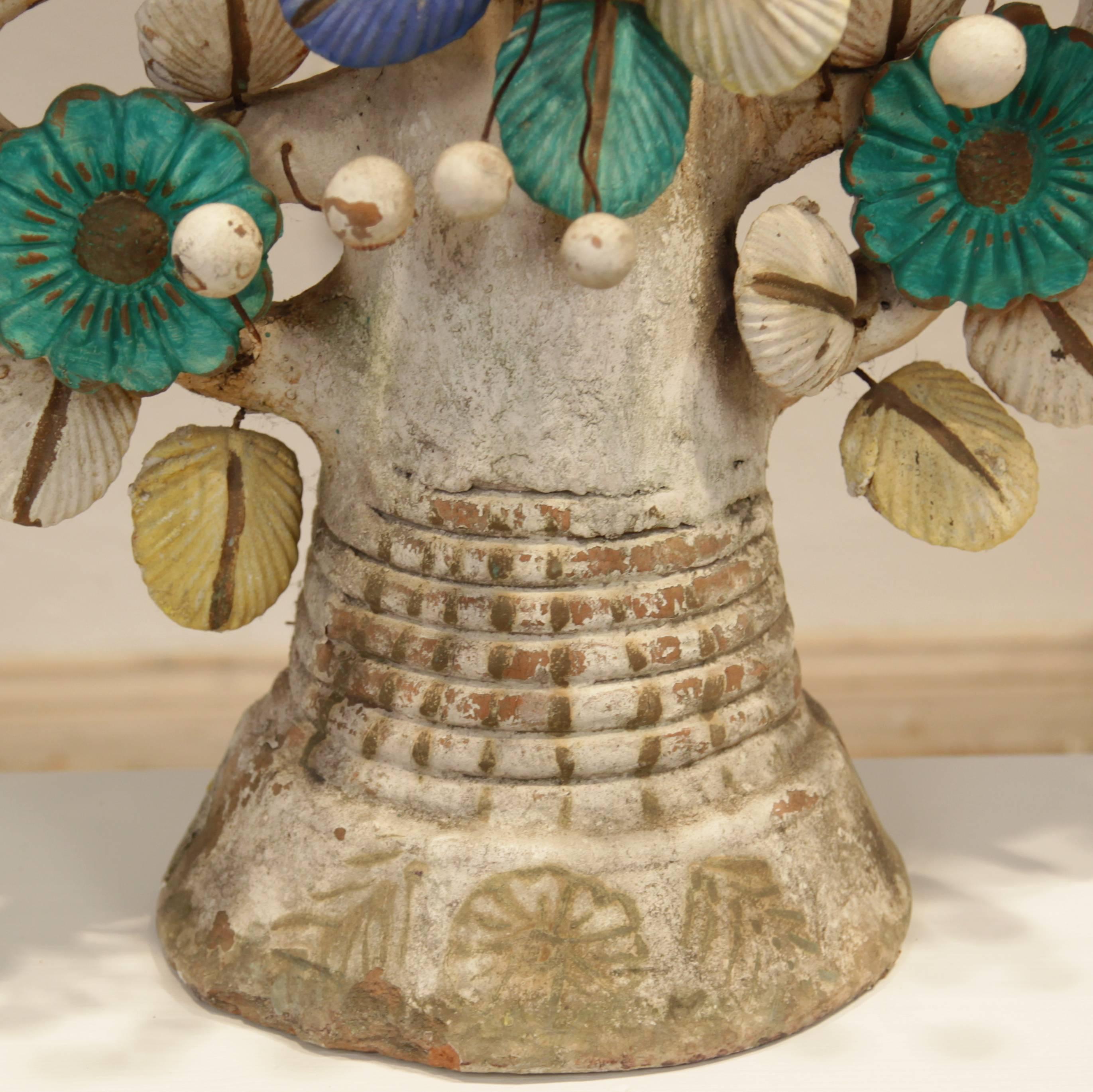 This big Mexican altar lamp, circa 1920 and shows tree of life with Adam, eve and the snake in the middle. It is out of fireclay and was hand-painted afterwards.
It is a wonderful decorative object.
A few bits and parts are broken and the candle