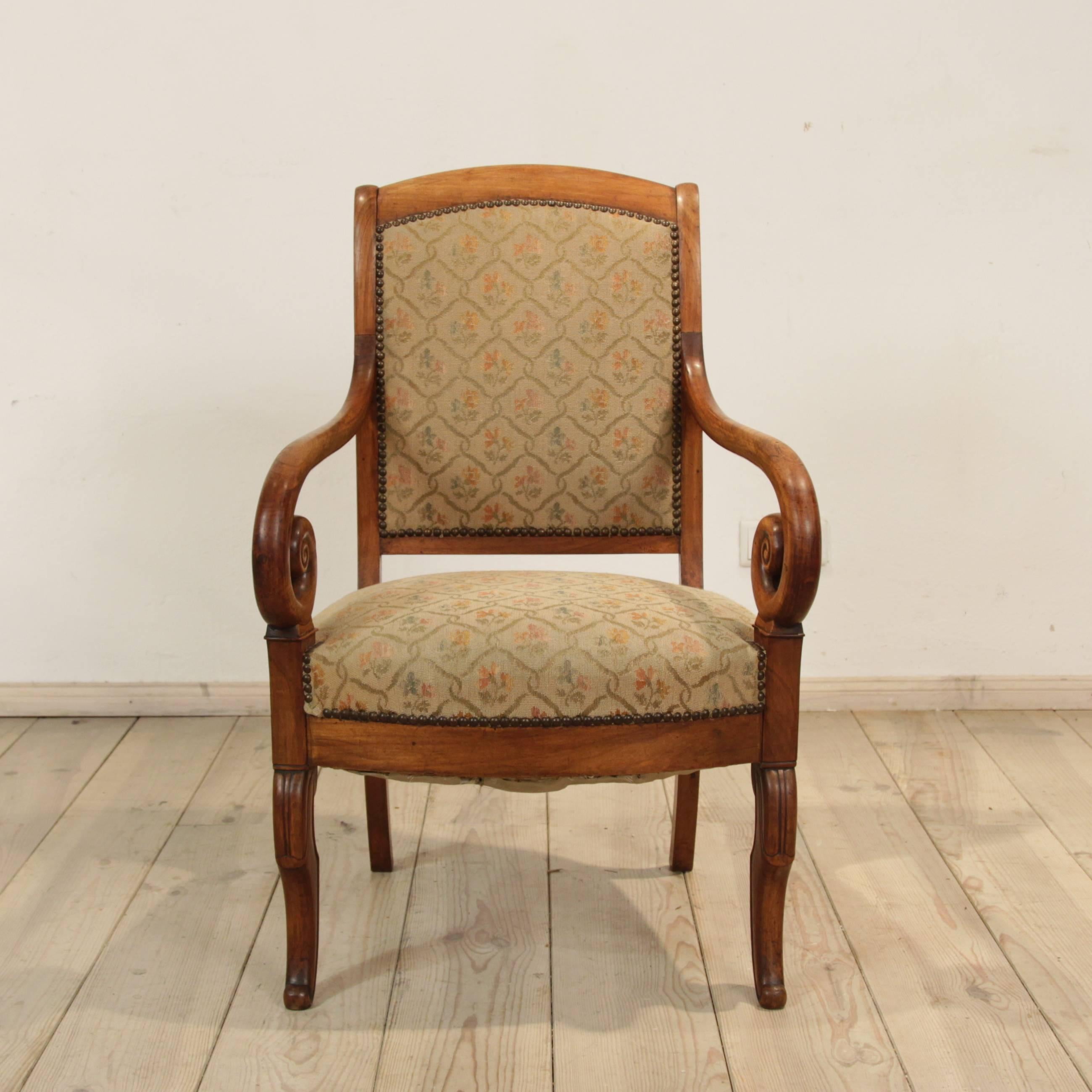 Fine antique French armchair, circa 1840. Beautiful lines with nice carving, curved back and cabriole legs. Rich and deep patina with the original upholstery. Excellent condition. A very comfortable and unique piece.
