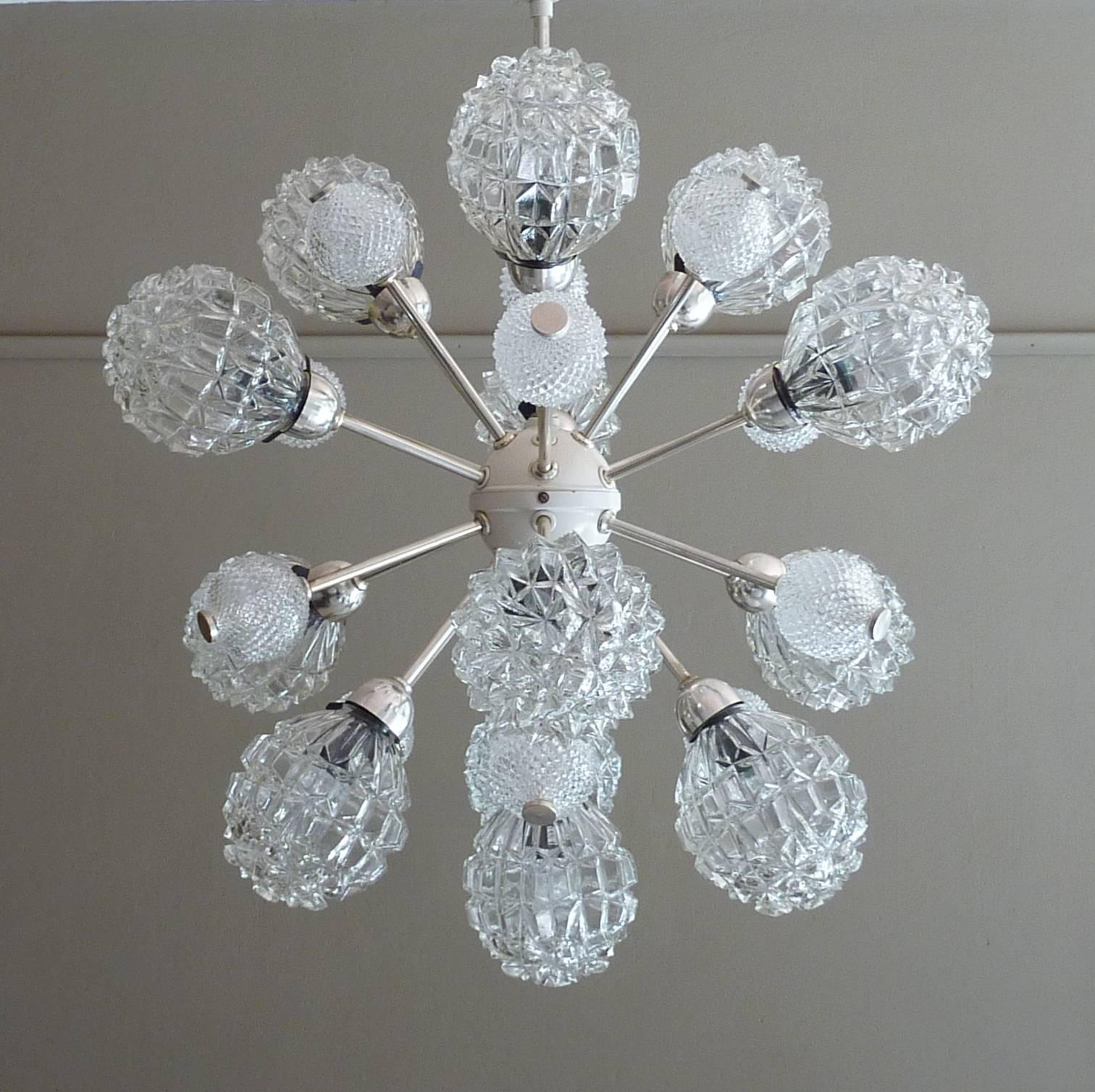 This German vintage chrome and textured glass bubble Sputnik chandelier by Richard Essig was produced in the 1970s. It was Produced in the DDR. It is in Good vintage condition. The Chandelier makes a great light a fits to Modern as well to classical