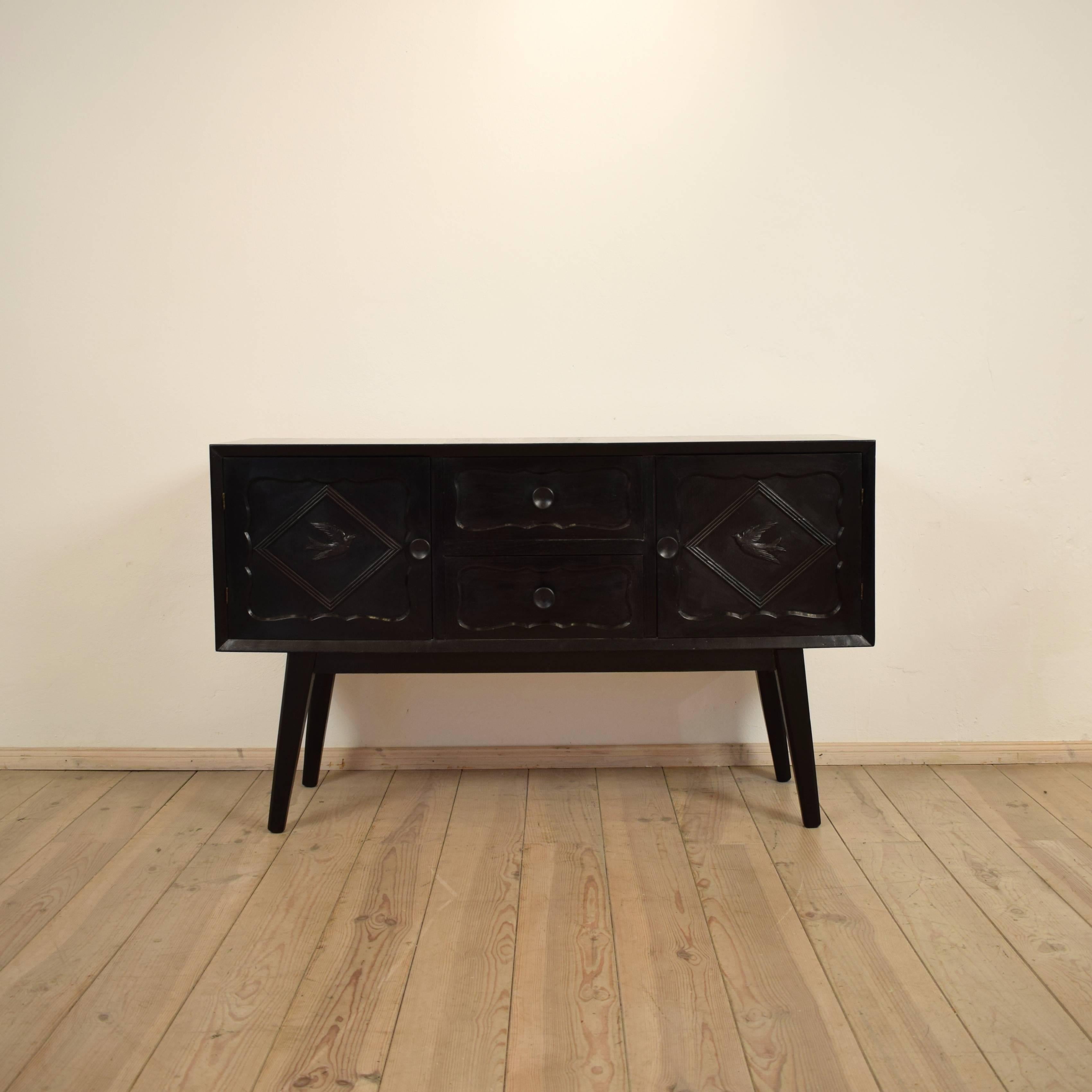 This unusual 1950s black sideboard in the style of Paolo Buffa is made out of ash and ash veneer. It has two drawers and two doors. The inside is lacquered in a mint color. This elegant sideboard fits good to a modern interior.