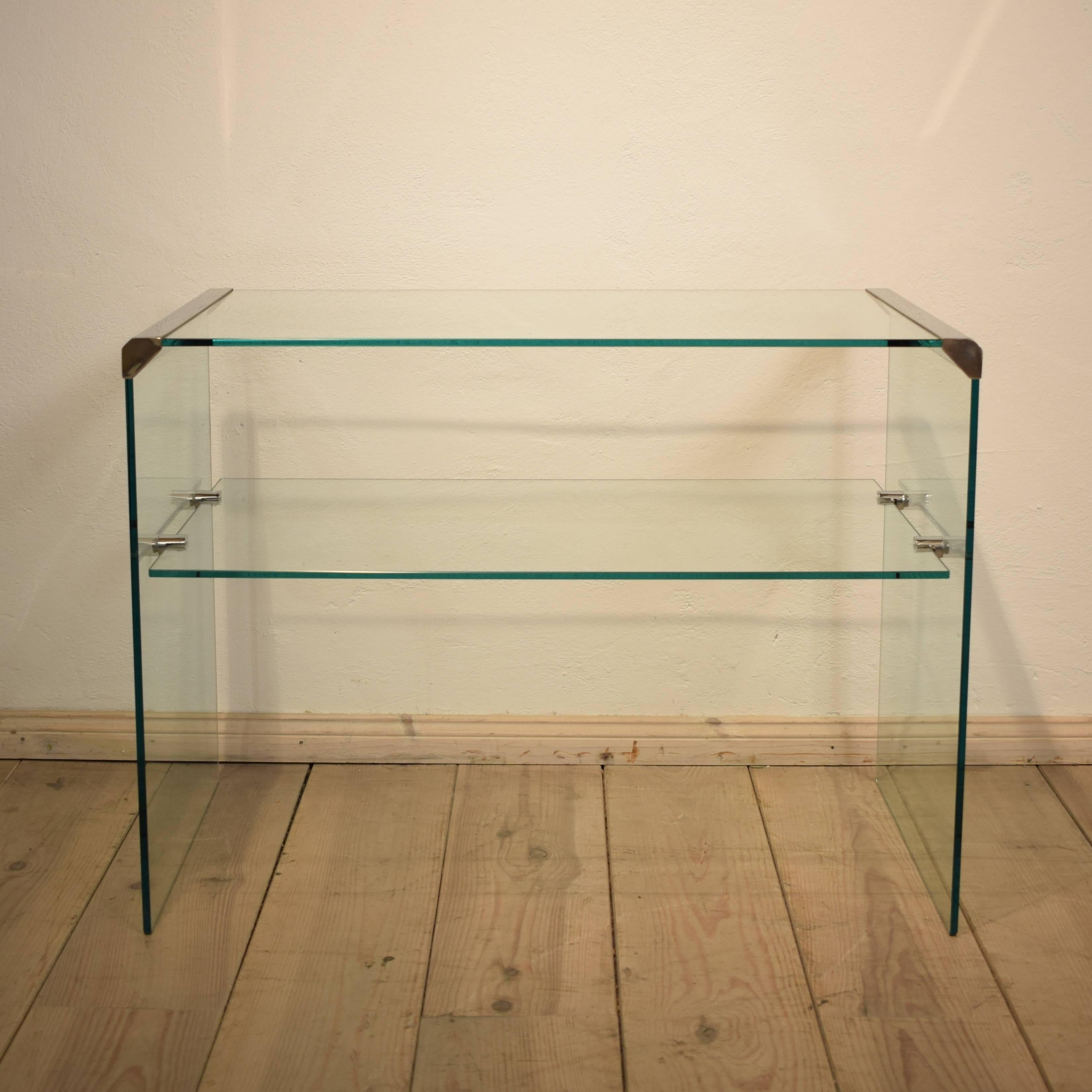 This Italian glass console table from Pierangelo Gallott. Was produced in the 1980s by Gallotti & Radice. The console has thick tempered transparent glass and has stainless steel edges. 
The console is in very good Vintage condition and fit to