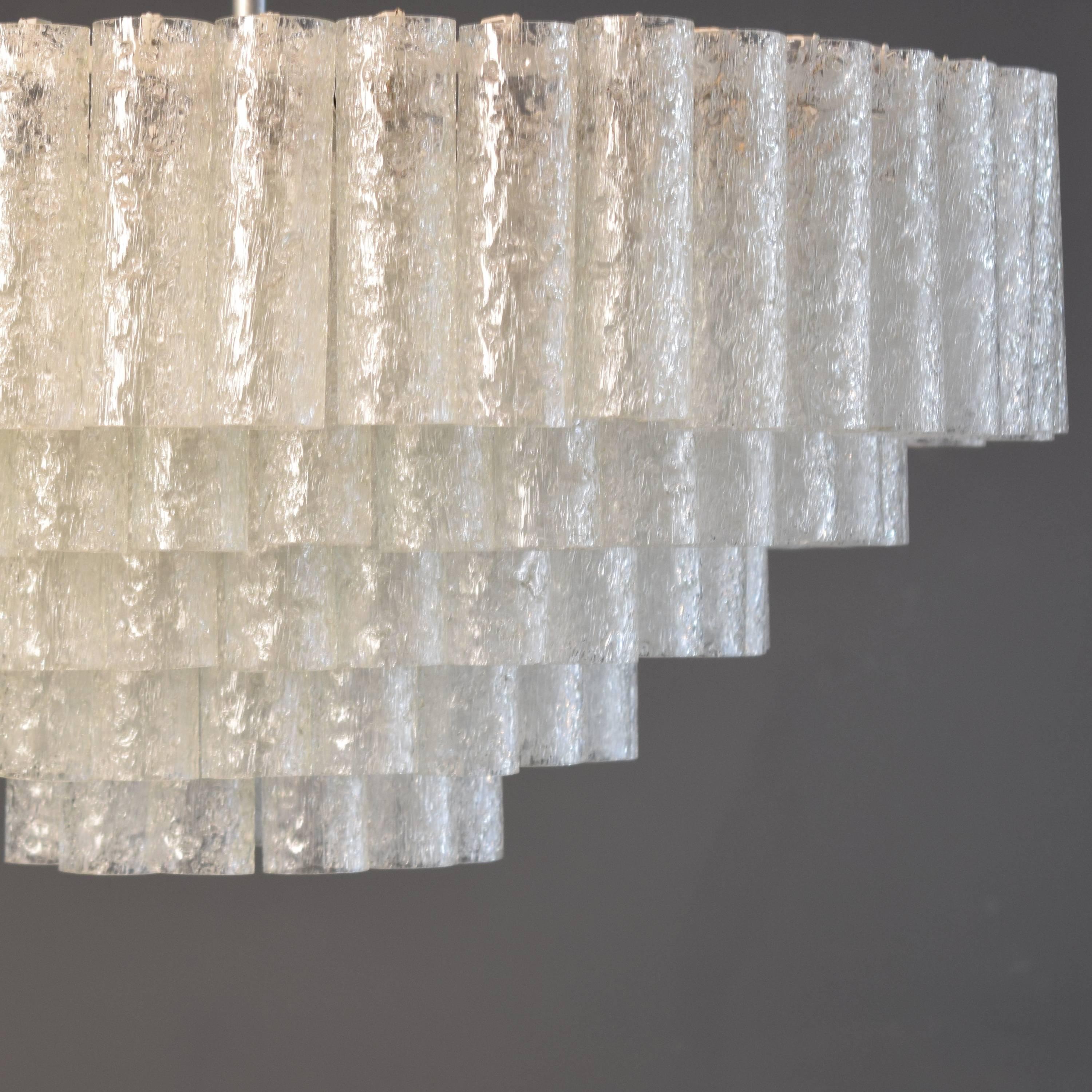This large five-tire crystal chandelier by Doria was manufactured circa 1960 in Germany. It has Murano glass tubes. This is very rare. Normally it comes with four tires.
It makes a very nice light and fit good to a modern or an antique