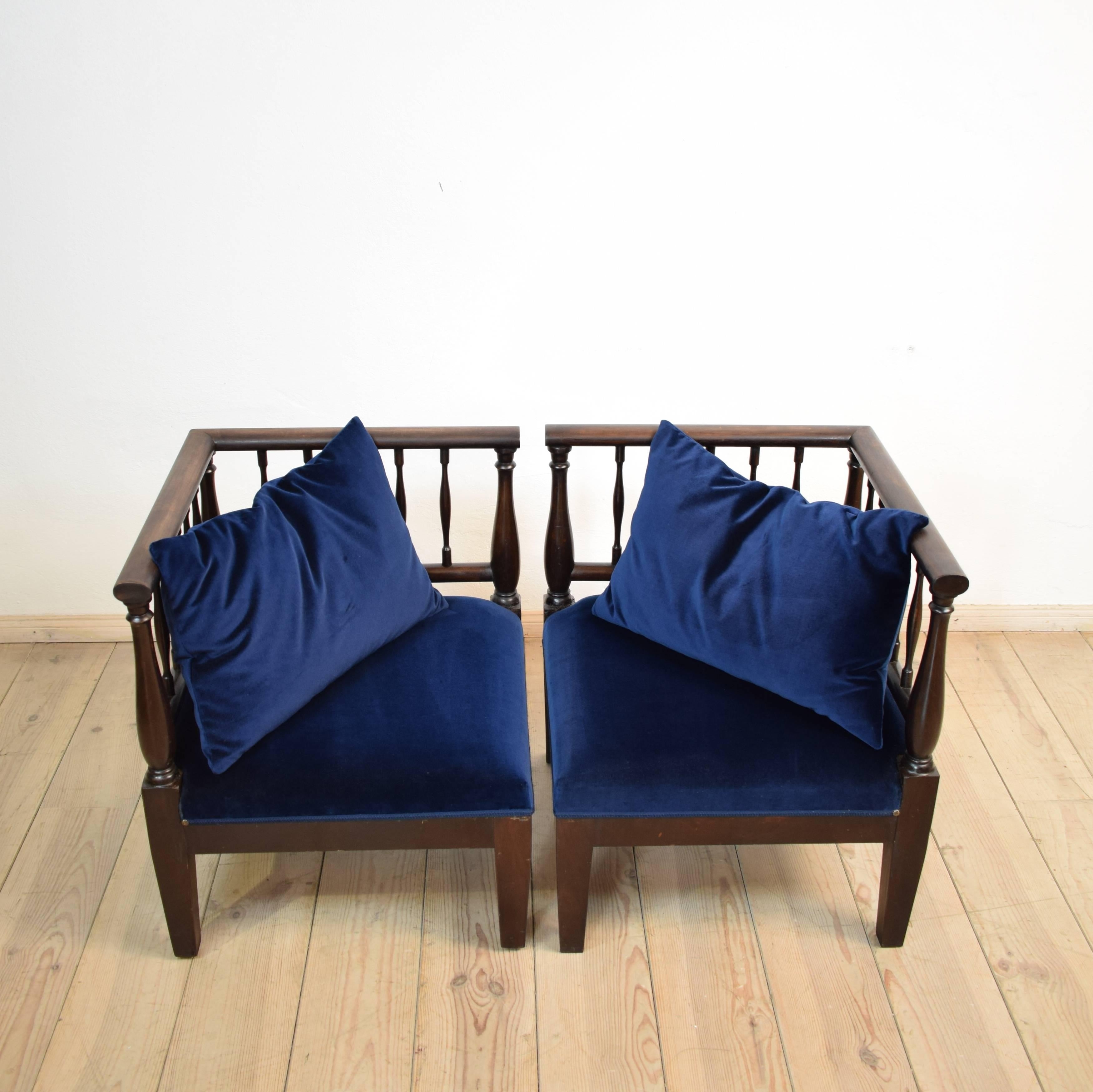 This 19th century pair of armchairs / loveseat is made out of mahogany and was re-upholstered in dark blue velvet. It comes with the matching pillows.
A very elegant and unique piece of furniture.
