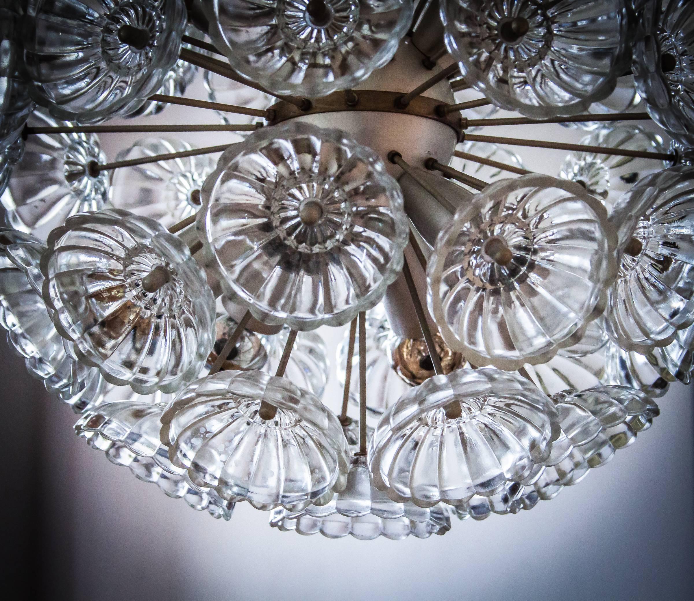 Beautiful designed crystal glass starburst chandelier from the early 1960s-1970s. Manufactured at VEB Leuchtenbau Ebersbach. This collectors item is a find from a period that never comes back. The silver version of the dandelion is a very rare