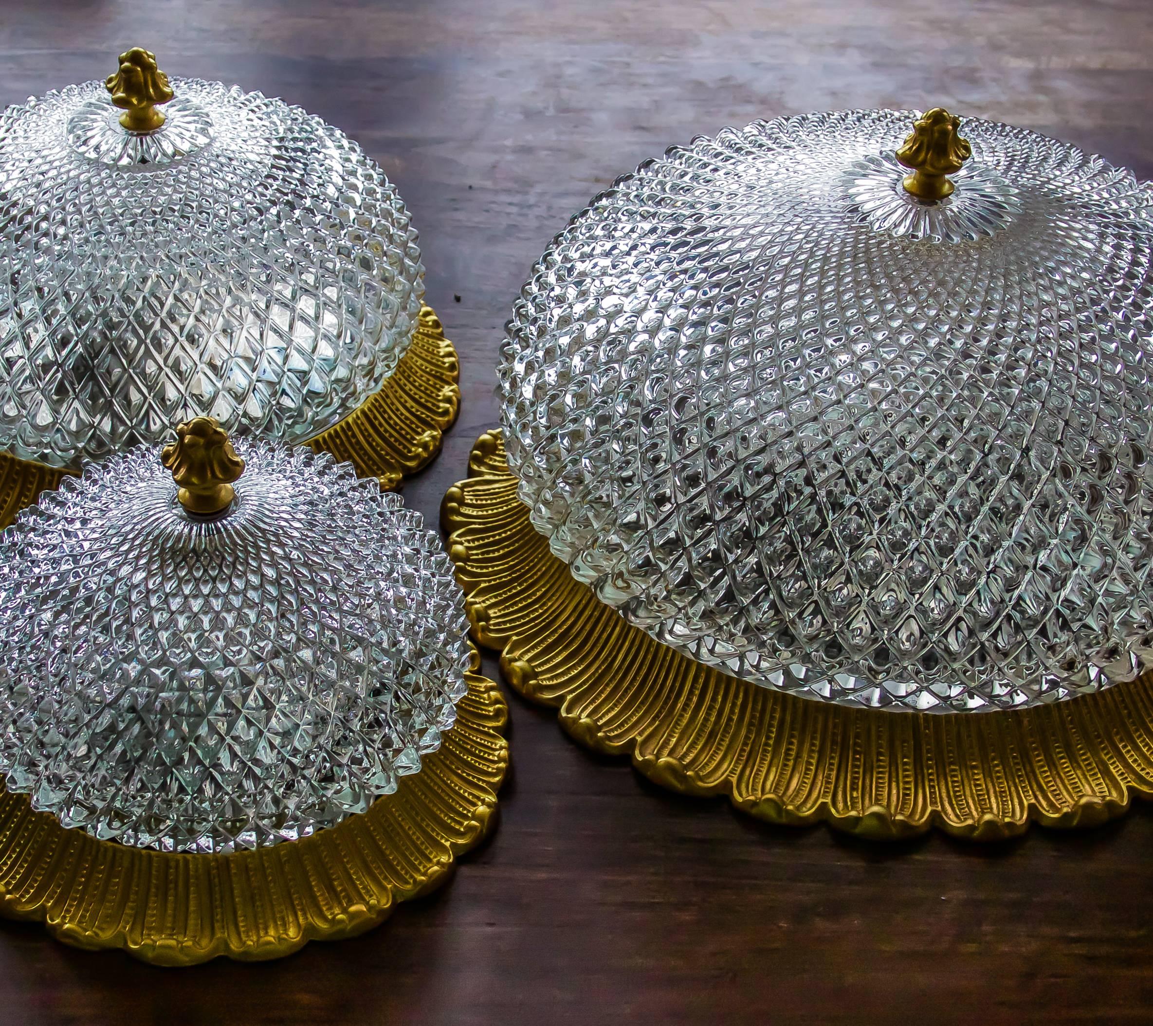 These Plafoniere lights have a romantic, neoclassical appear on a gilt cast iron frame that carry the textured crystal glass globe with its blossom top.

All three flush mount, wall or ceiling lights are in perfect condition and make a great