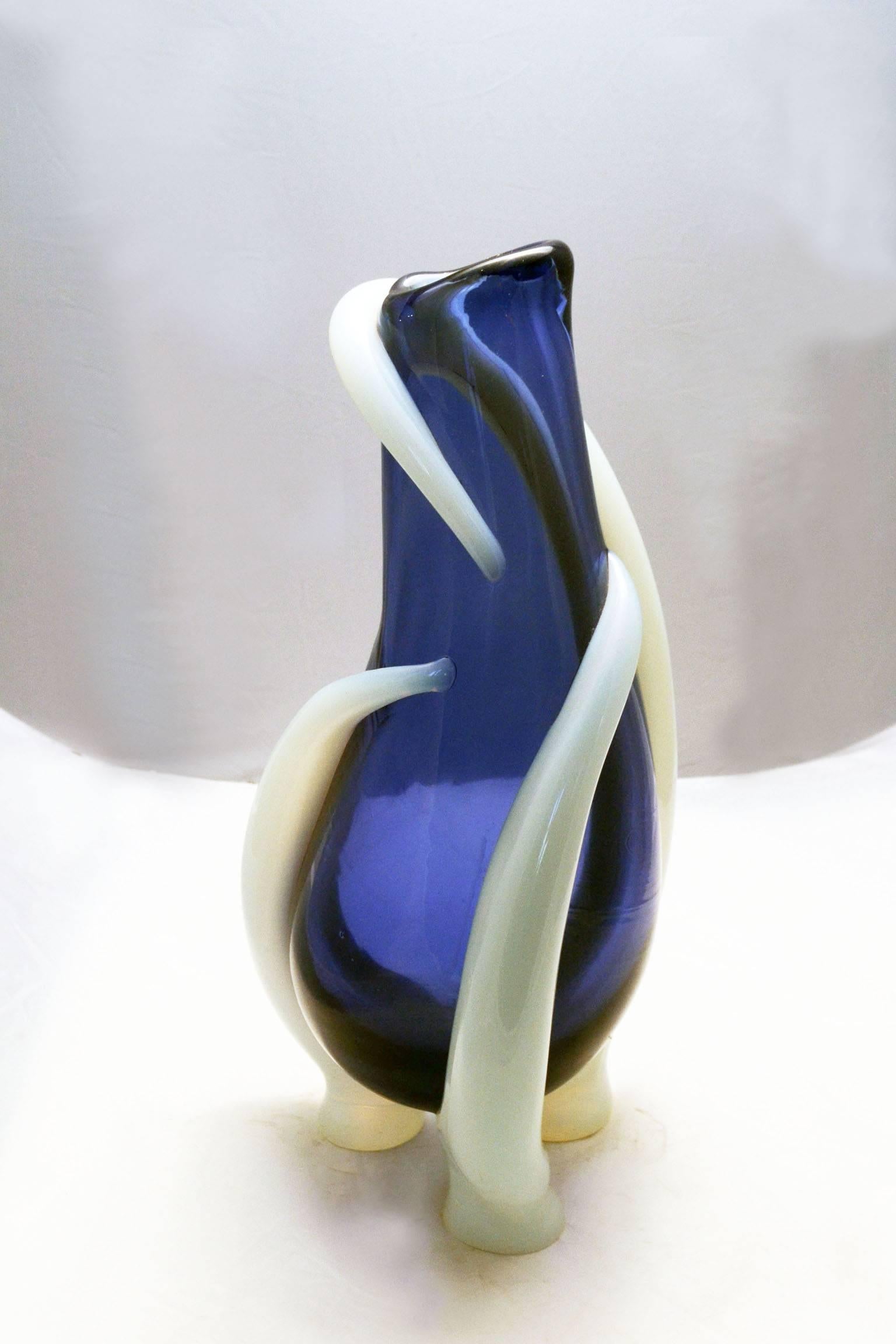 Sculpture vase designed by Claire Falkenstein for Vetrerie Salviati - Murano, in occasion of 'Biennale Vetro' in 1972.
In blue glass with hot application of oplaine glass.
Limited edition of nine pcs.
Signed and numbered on the bottom.