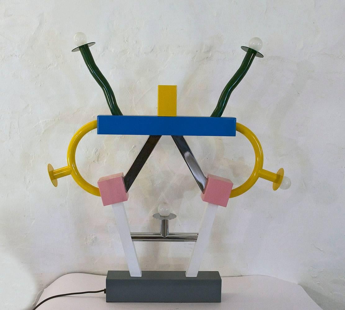 Ettore Sottsass 'Ashoka' table lamp, 1981 Memphis Milano.
In painted and chromed metal, with five lights and one alogen light inside the top yellow piece.


 