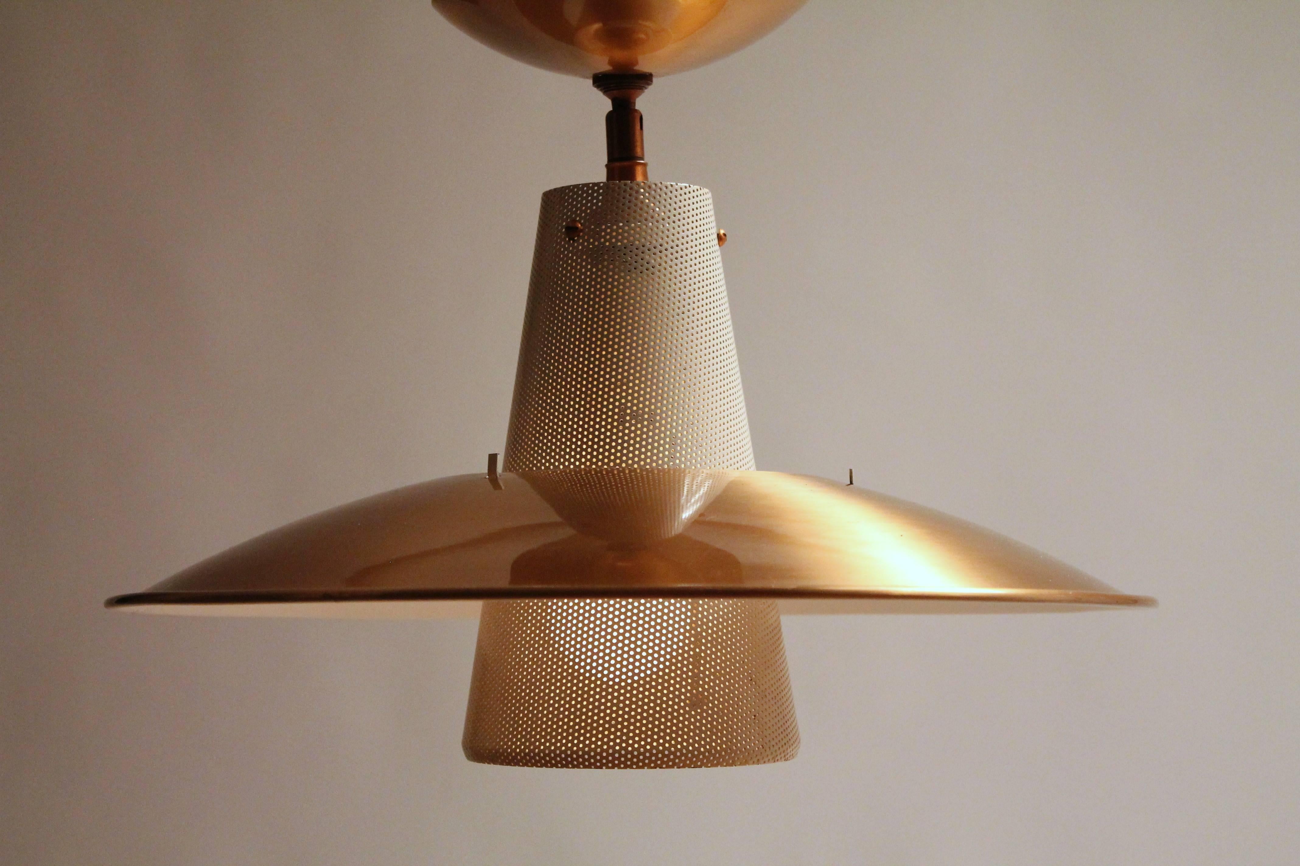 Simple Minimalist modern line , copper plated aluminium shade and hardware, perforated enameled steel funnel to damper harsh light.

Measure 17 inches wide by 12.5 inches high from canopy to bottom of lamp . 

  