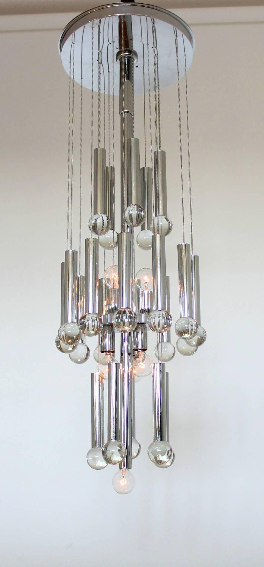 Modern elegance from the 1970s. 

The center stem contains five candelabra size sockets and is showed here with clear light bulb, blending in with the glass balls, creating a powerful explosion of reflection on the chrome tube while