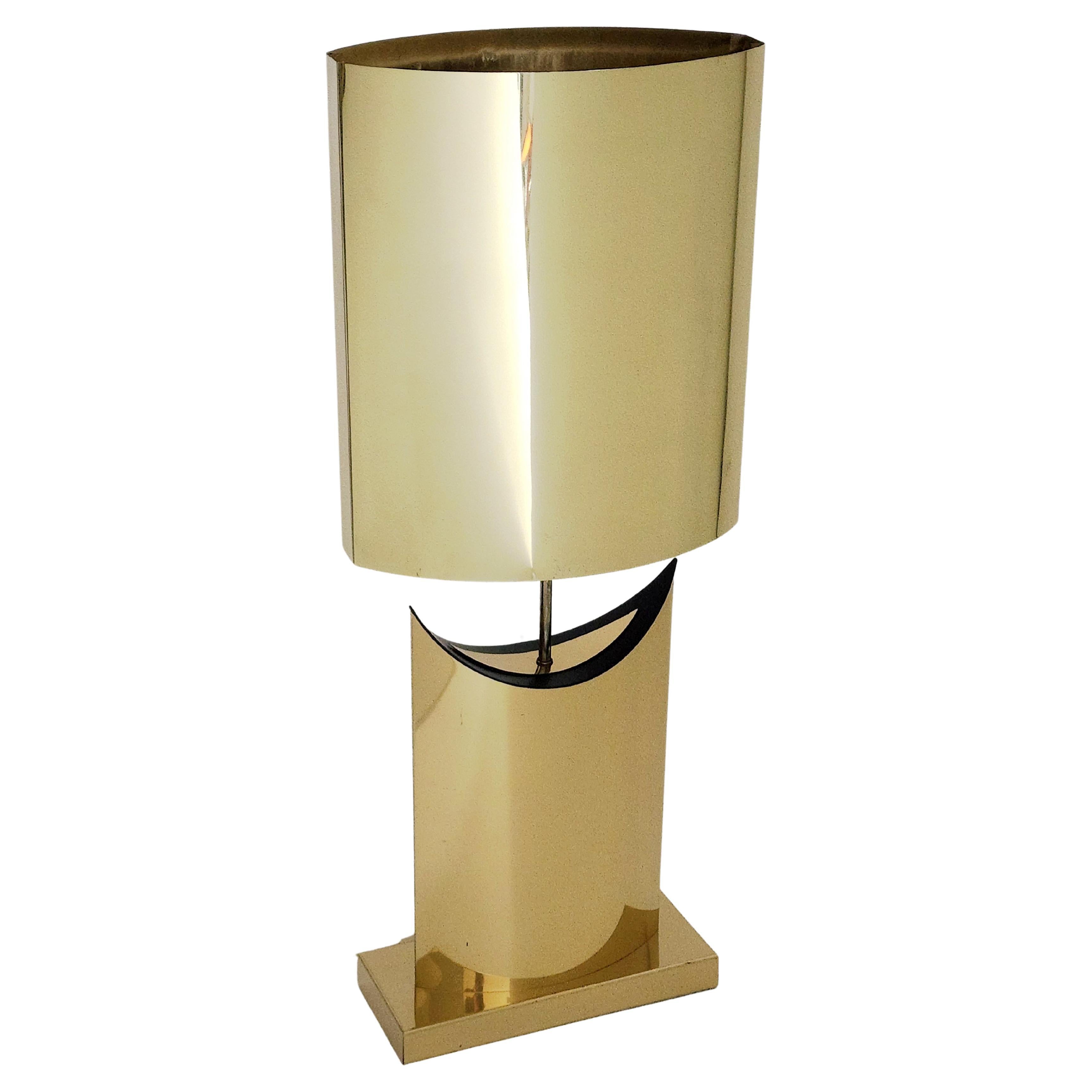 Bold table lamp with a lot of presence and personality in very good condition .

Lacquered brass plated steel. 

Warm glow when lighted.

Measure: 37.5 inches high by 15.25 inches wide.

One regular E26 socket rated at 100 watts.

Switch