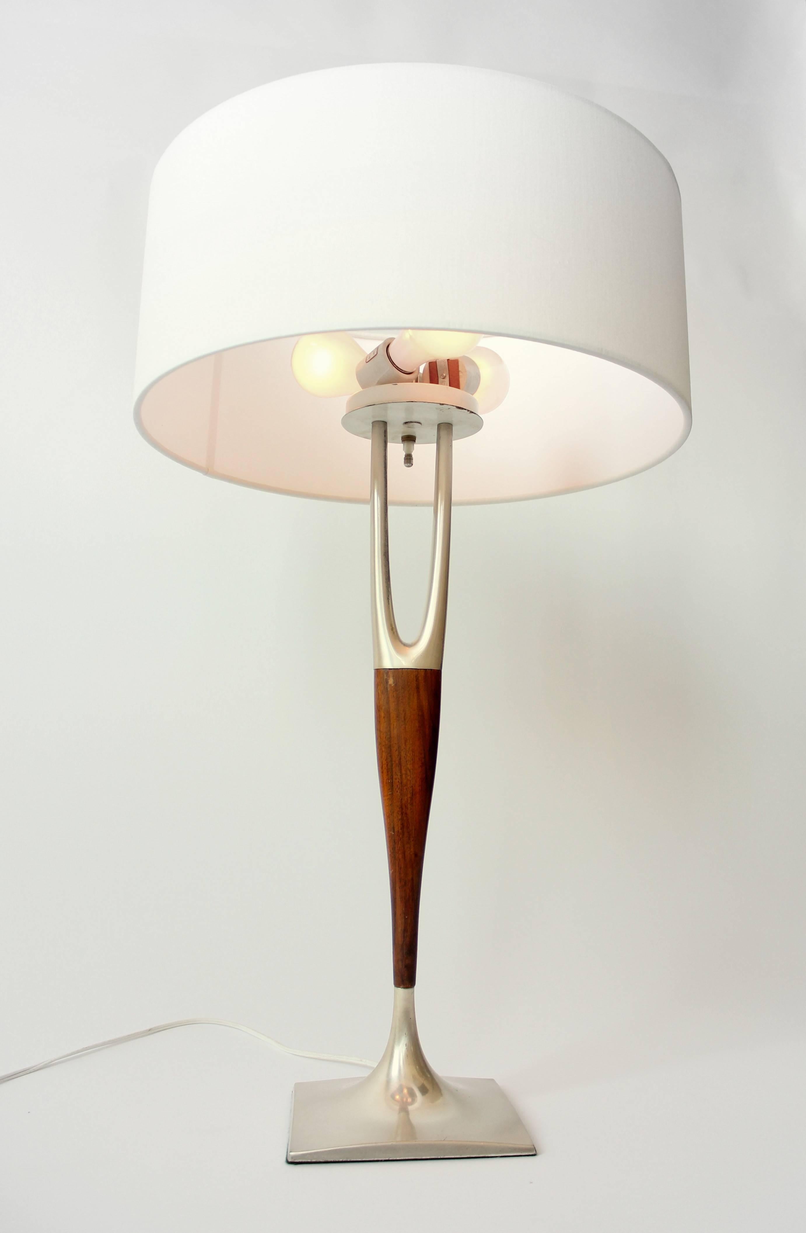 Lacquered brushed aluminum base and wishbone. Walnut stem.  

Laurel Model H-465 Designed by Harold Weiss and Richard Barr . 

Three ceramic E26 size socket paired with a rotating switch controlling one, two or three lights.

Provide more light and