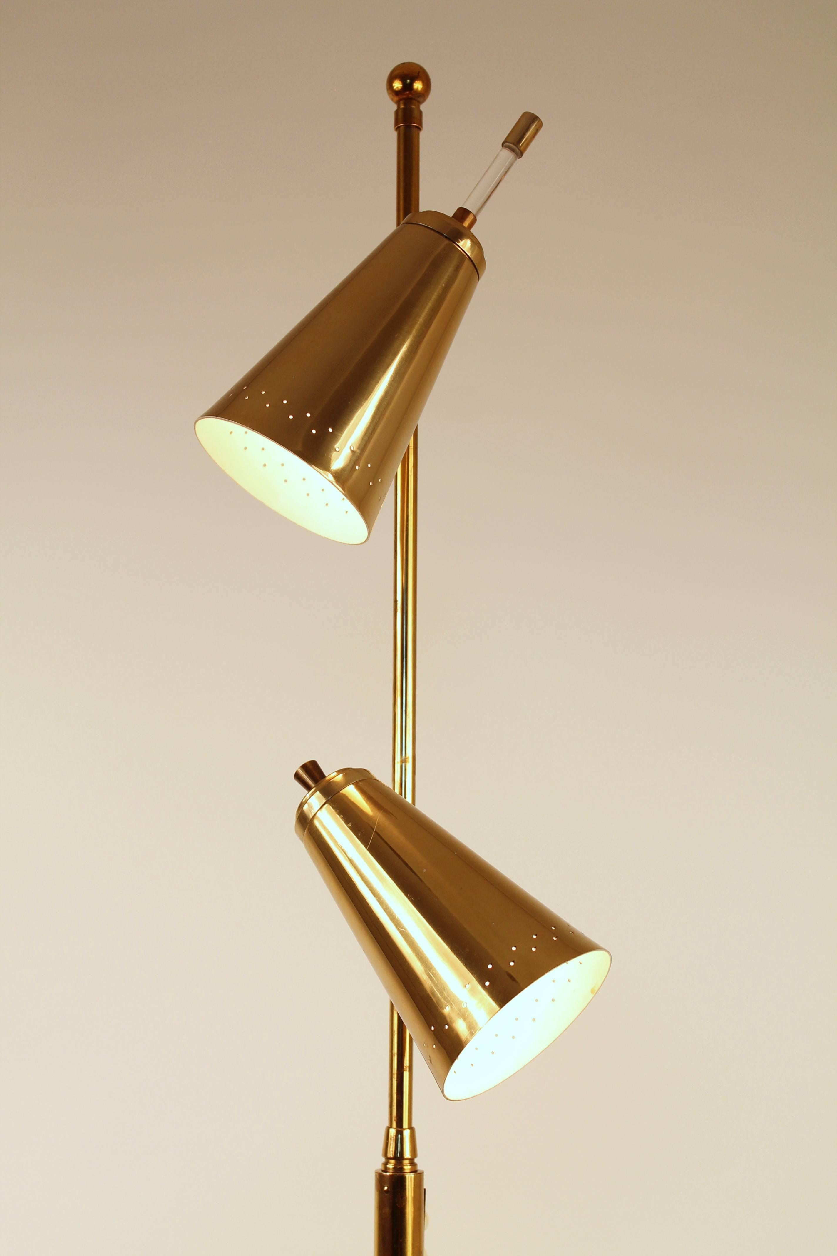 Finely pierced conical brass shade .

One shade is  topped with a lucite and a brass finial. 

Walnut base and lower pole. 

Top stem and all remaining hardware are made of brass.

2 Regular E26 socket controlled by two individual ON/OFF rotating