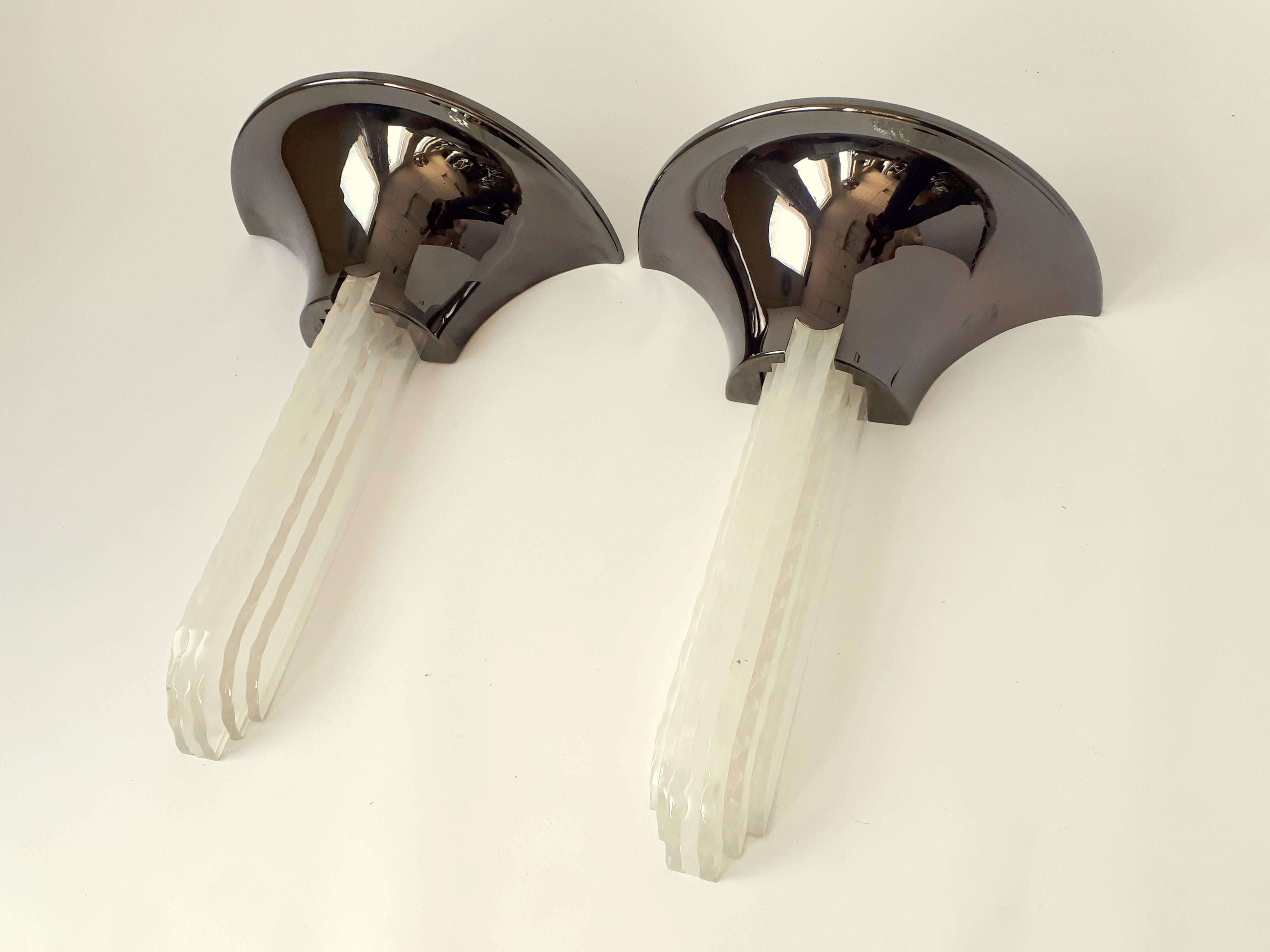 Iconic pair of Art Deco style sconces. 

Extremely light conductive vertical sculptural (waterfall like) slice of Lucite stacked together, mounted on a brass structure plated  with a high gloss gun metal finish.

Measures: 22 in. high by 16 in.