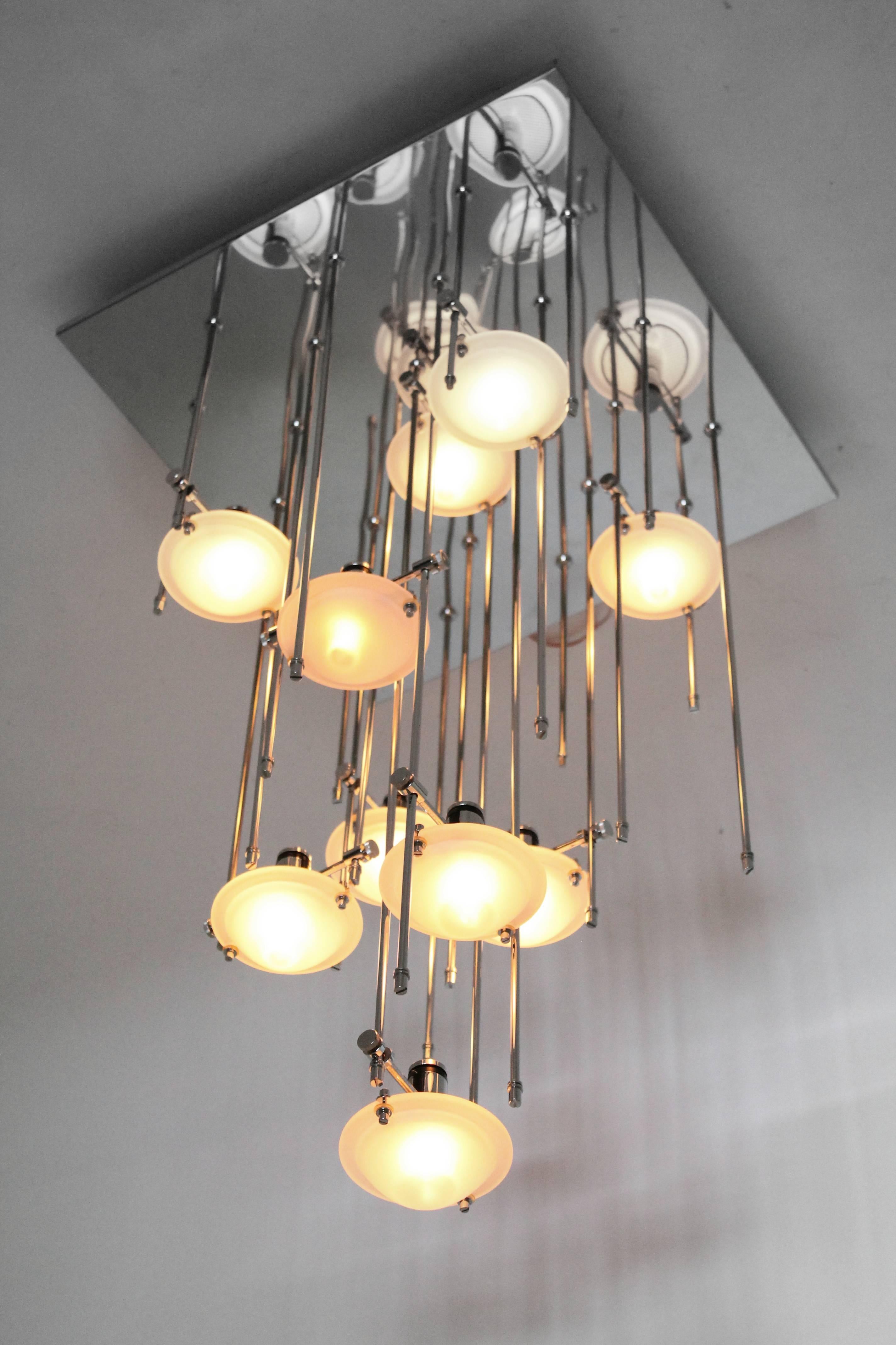 Interactive flush mount chandelier  by Lightolier. Get creative by selecting which length of rods goes where and at what height to put the thick opale Murano glass shade. 

The deep highly reflective chrome  plate multiply the number of perceived