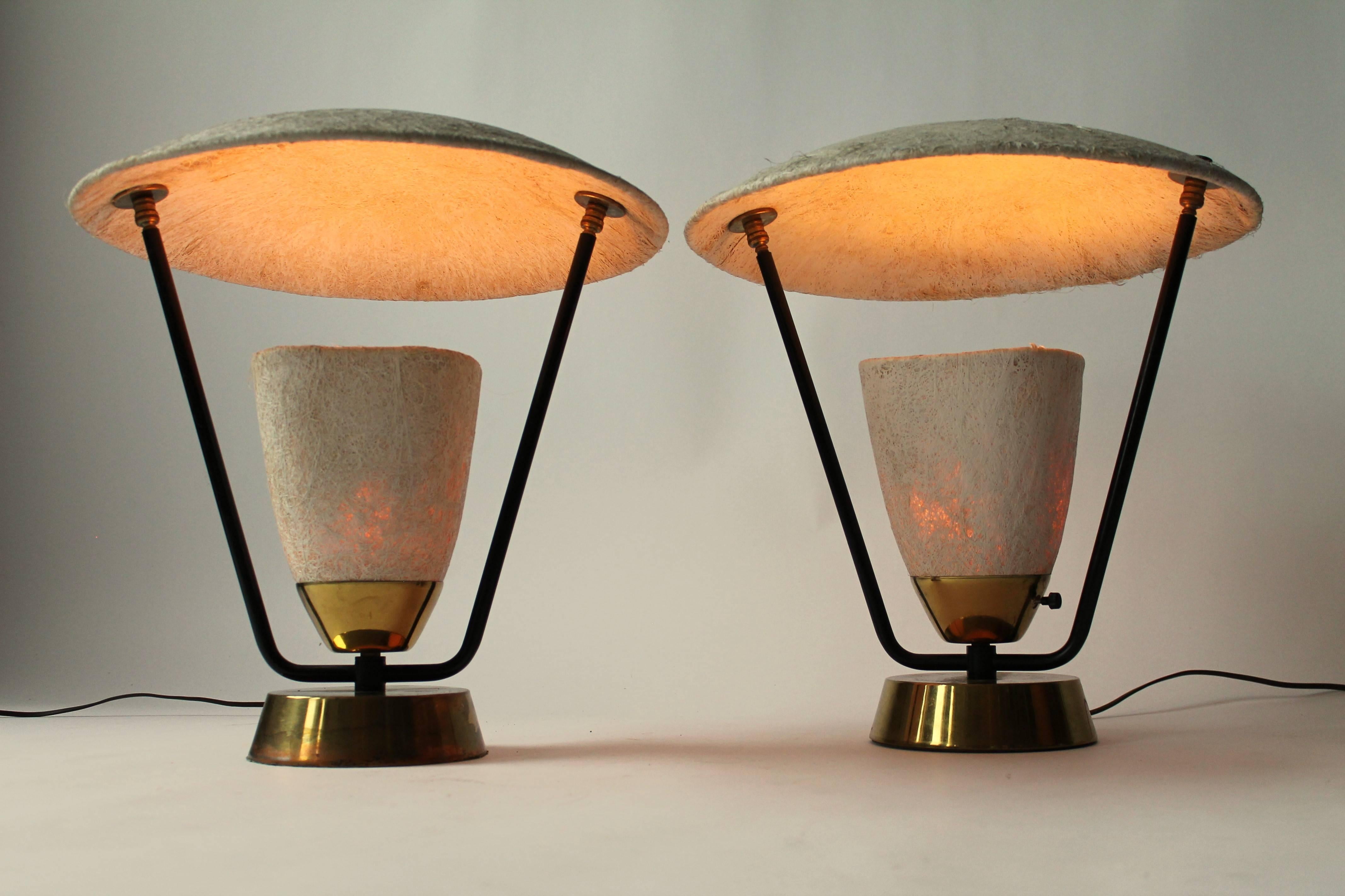 Pair of hand molded, pressed fiberglass shade and cone table lamp with brass base and hardware. Stem are enameled black steel.

The fiberglass is quite thick and opaque. They were made to have the light bounce on the dome producing a downward glow