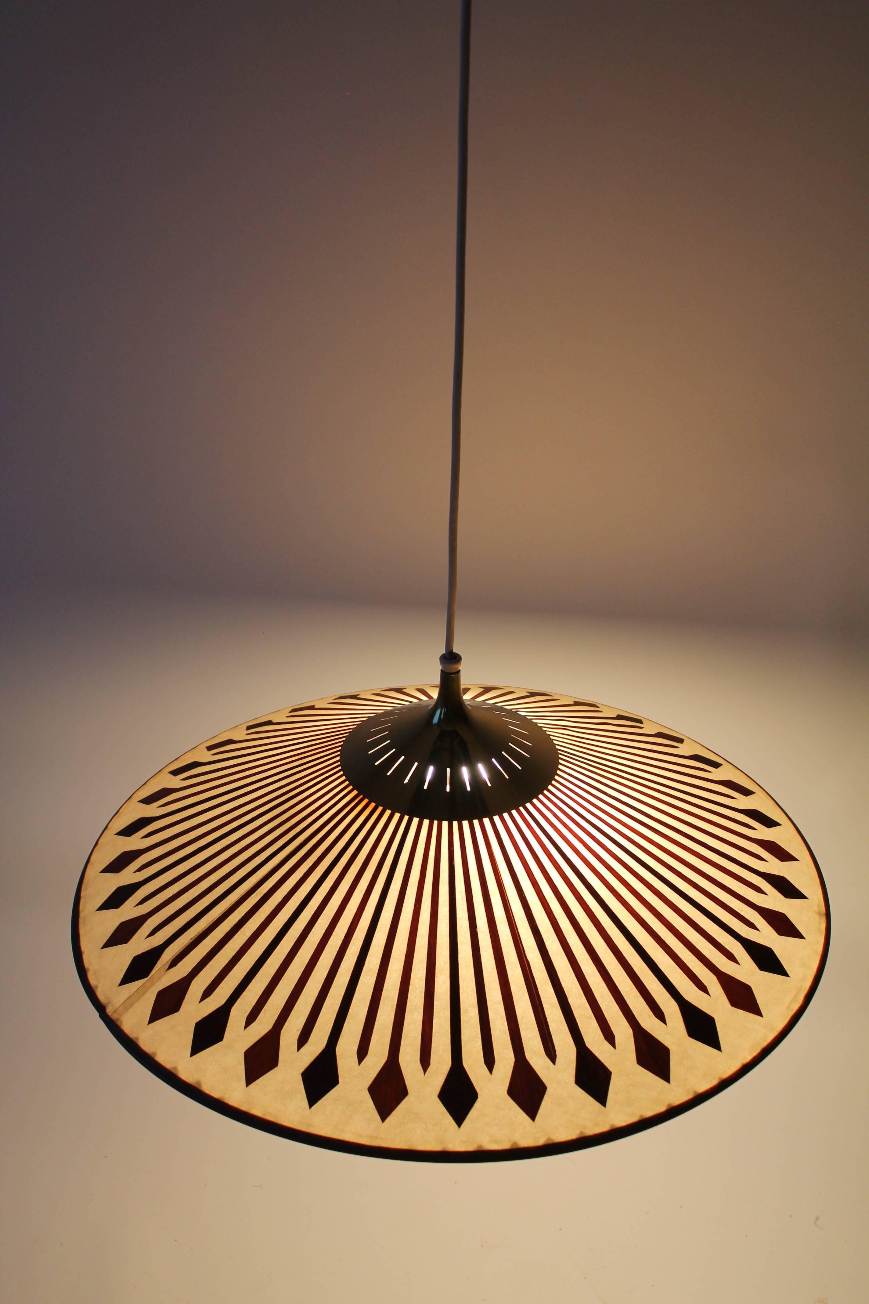 Classic Chinese hat style chandelier/pendant with die cutted thin slice of teak applied to the opale fiberglass surface revealing the color, grain and texture of this superb wood essence.

The glow emited by this lamp is very warm. 

Vented