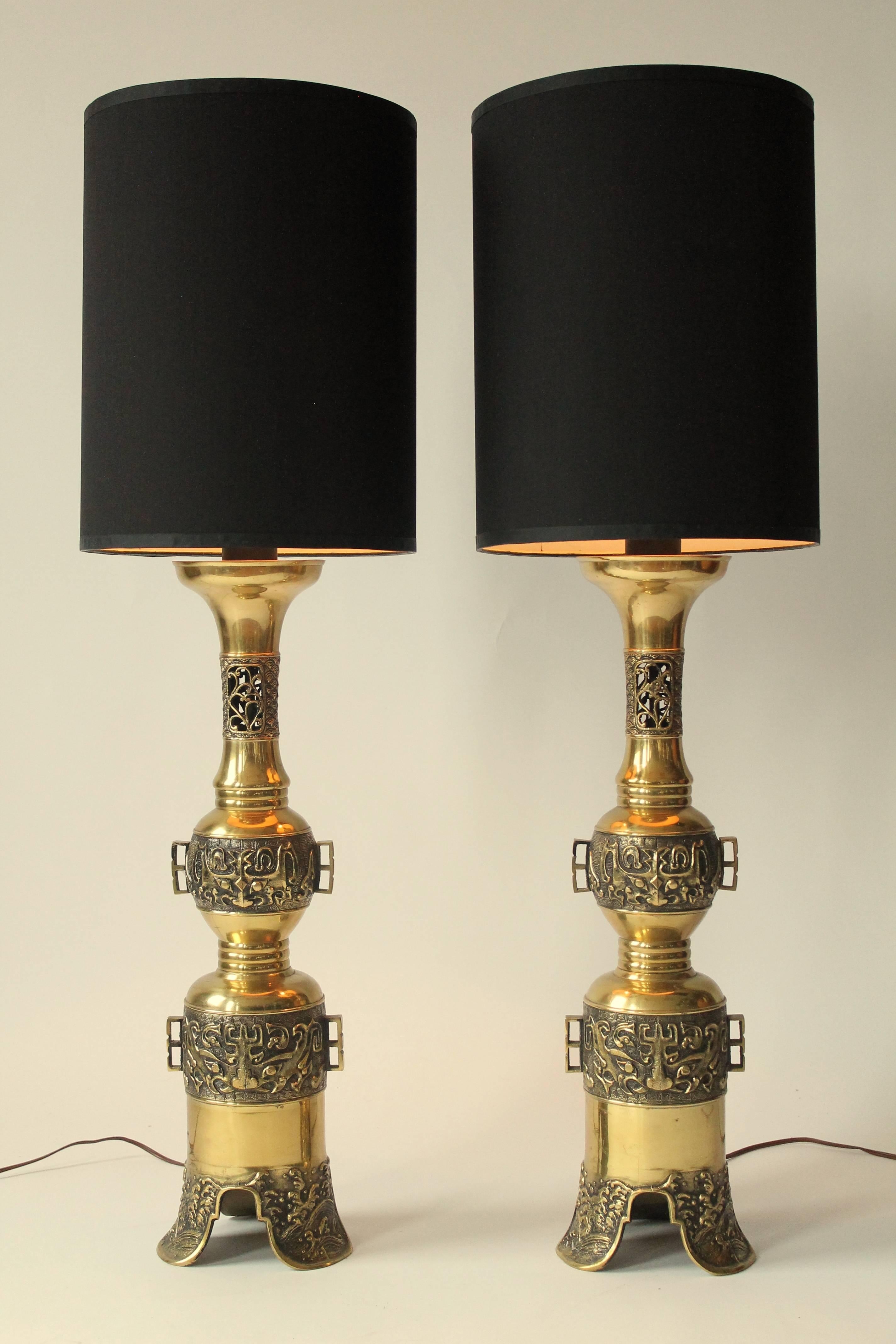 Prime quality Mid-Century  brass casted with a  near incised precision representing tribal motif with an Asian inspiration to it. 

The remaining of the lamp have been milled and polished. 

Each lamp weight 10 pounds. 

Measures: 38 to 42 inches in