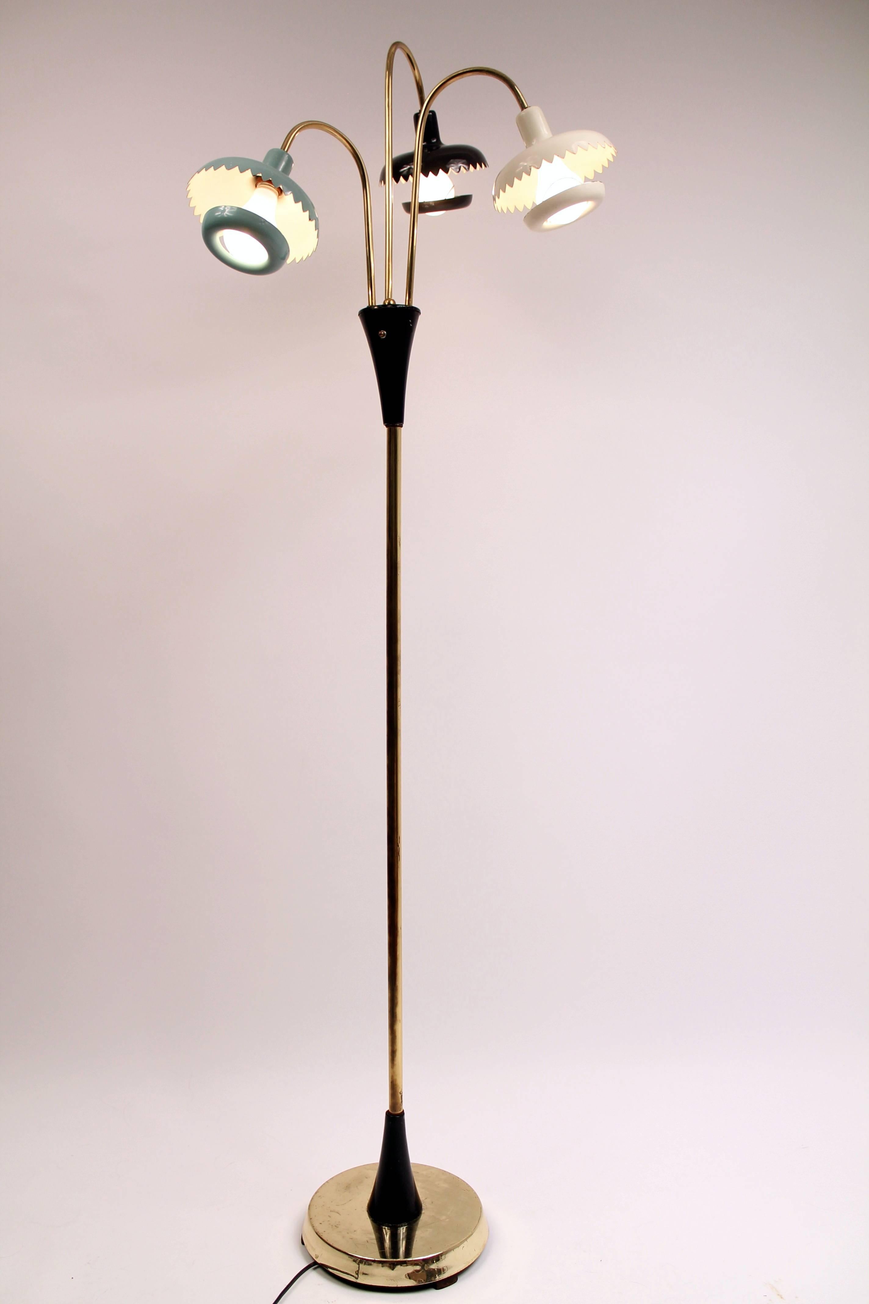 Three enameled metal heads and hooked cup on light bulb in primary color. Brass stem. Main pole and base are brass plated. 

Measure 64 inches tall.

Rotating switch control one, two or three lights.