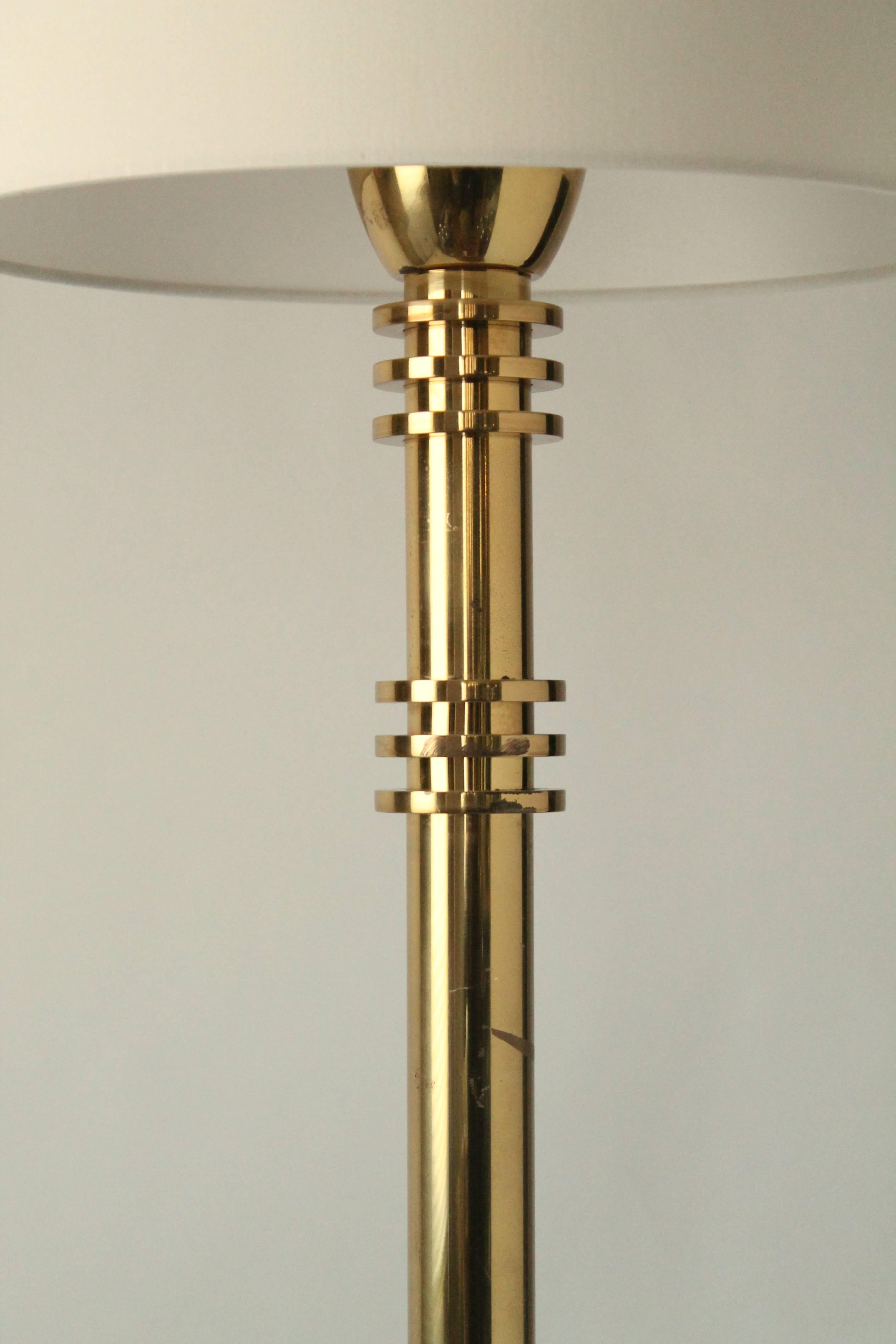 Minimalist modern, Machine Age, Art Deco style floor lamp. 

Measures: 65 inches high. 

One regular E26 size socket paired with an ON/OFF touch control with three intensity level.

Shade is for display only . Available on order . 
 