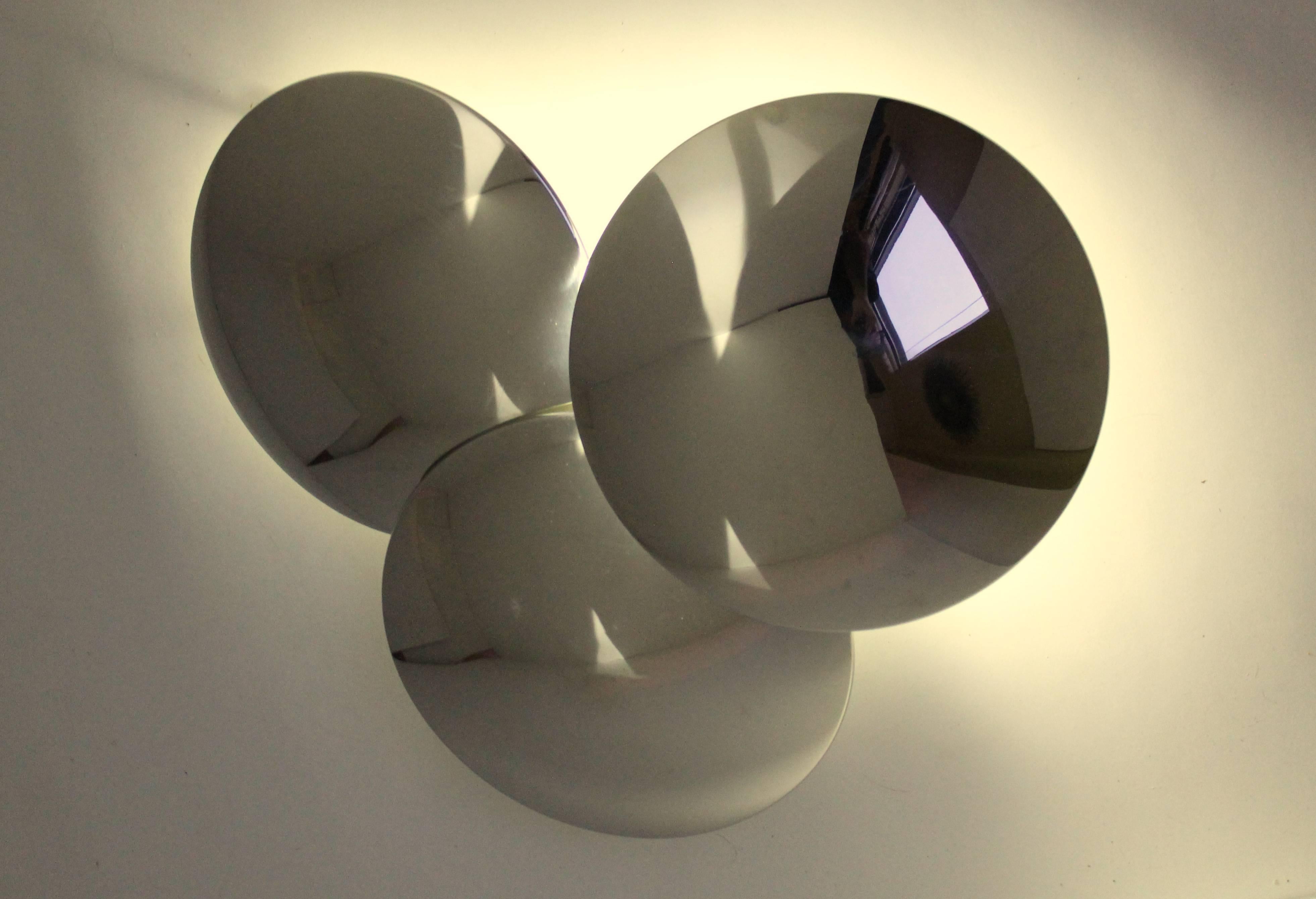 When lighted it project on the wall surface a ghostly, aura like effect from under and on the outer edge of the CAP, leaving the sconce itself in the shadow. 

Each disc measure 11 inches diameter. 

Contain one regular E26 ceramic socket rated