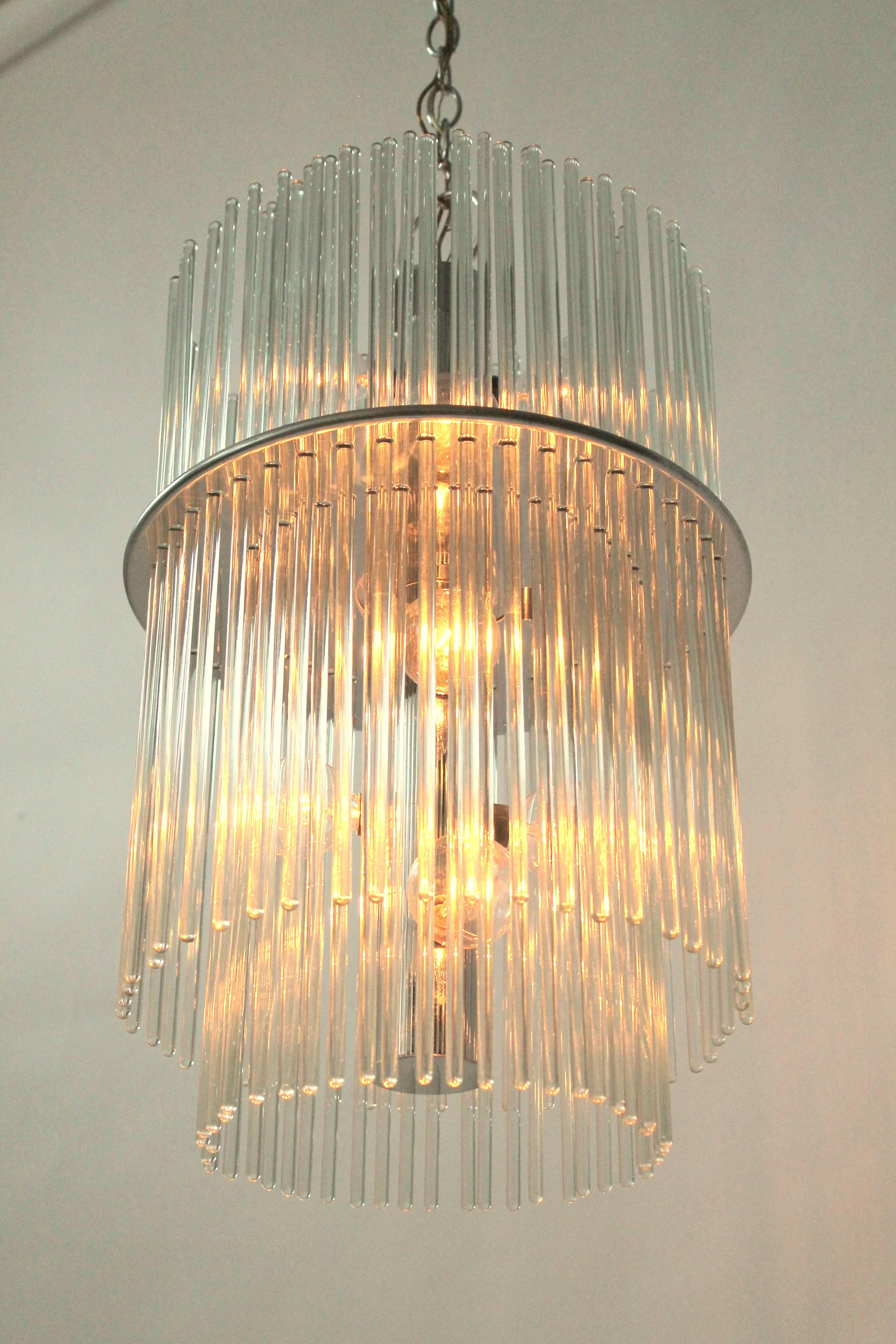Classic 80s Lightolier chandelier from their Radiance line .

Two row of light catching optical quality glass rods sitting on a nickel plated  pierced steel plate.  

Contain 10 E12 candelabra size light bulbs. 

Well made solid construction.