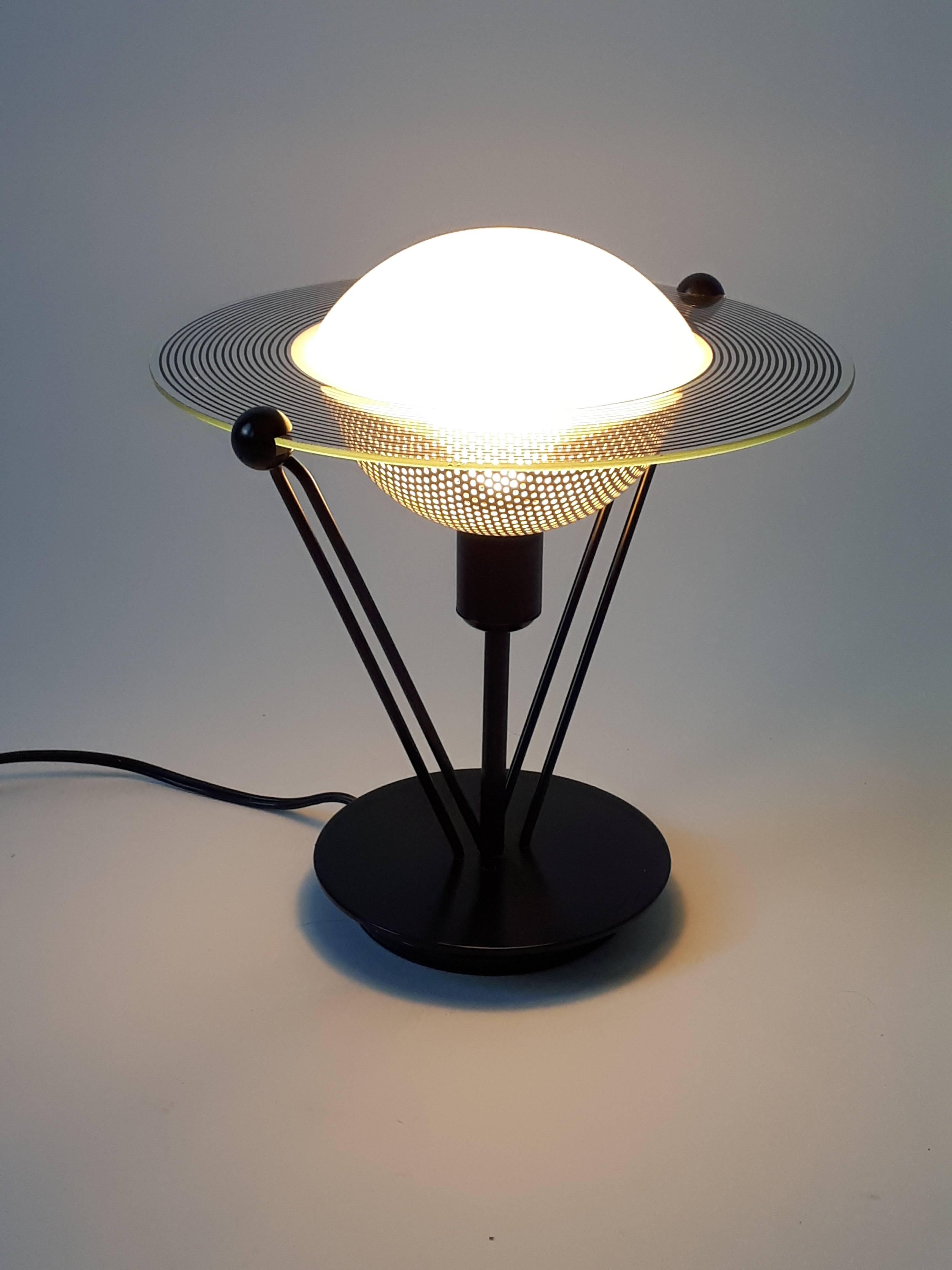 Small , solid and well made black semi-gloss metal base and structure.

Off white  pierced grill under. 

Measure 10.5 inches high. 

Contain one E12 candelabra size light bulb rated at 60 watts max. 

Switch on cord.
