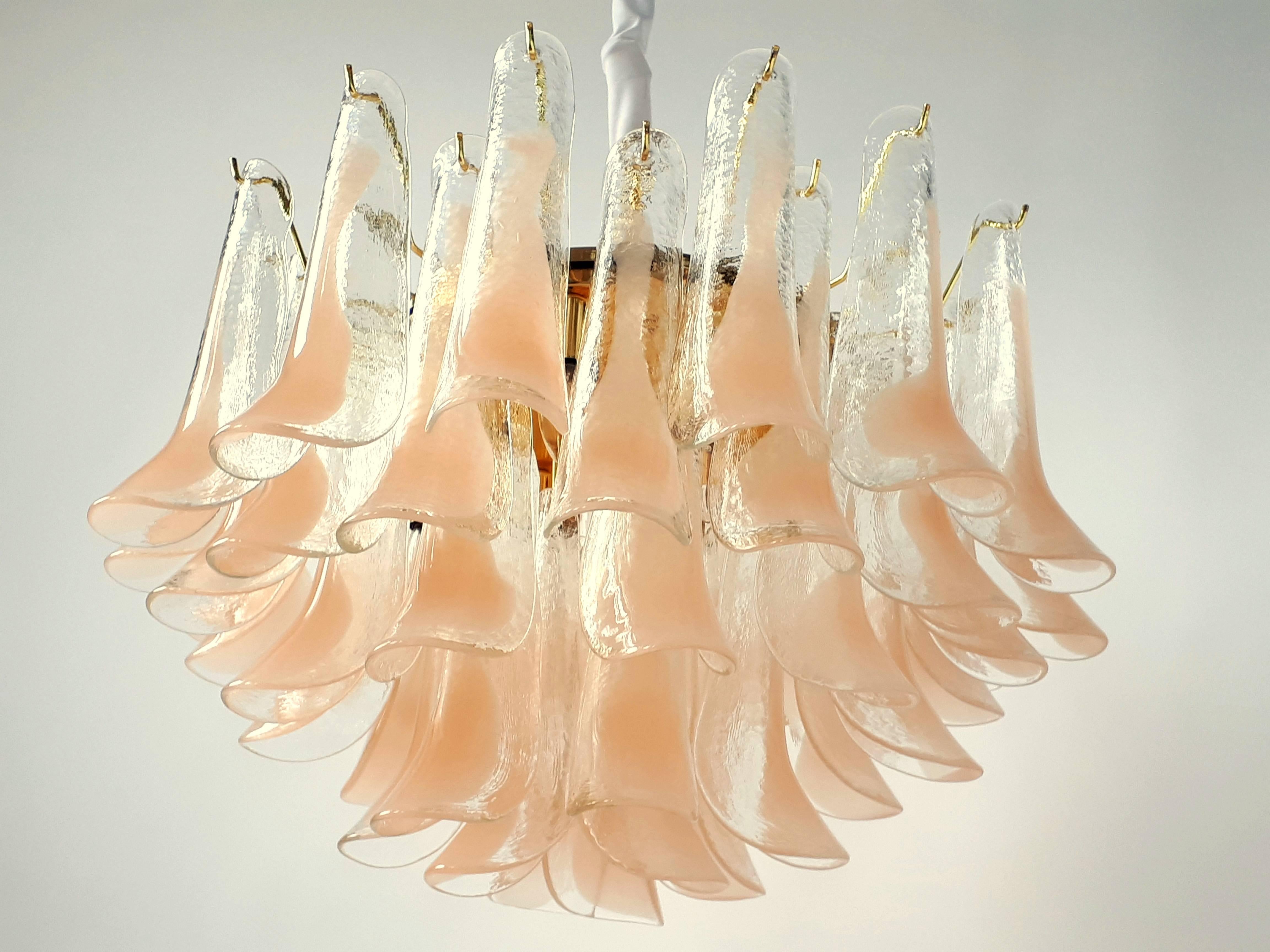 Thick sculptural texturized mouthblowed glass petal in a peach tone color 

Very warm glow while lighted. 

Mounted on a brass-plated frame.

11 regular E26 size socket. 

Measures: 29 inches wide by 24 inches high.

Weight 70 pounds.