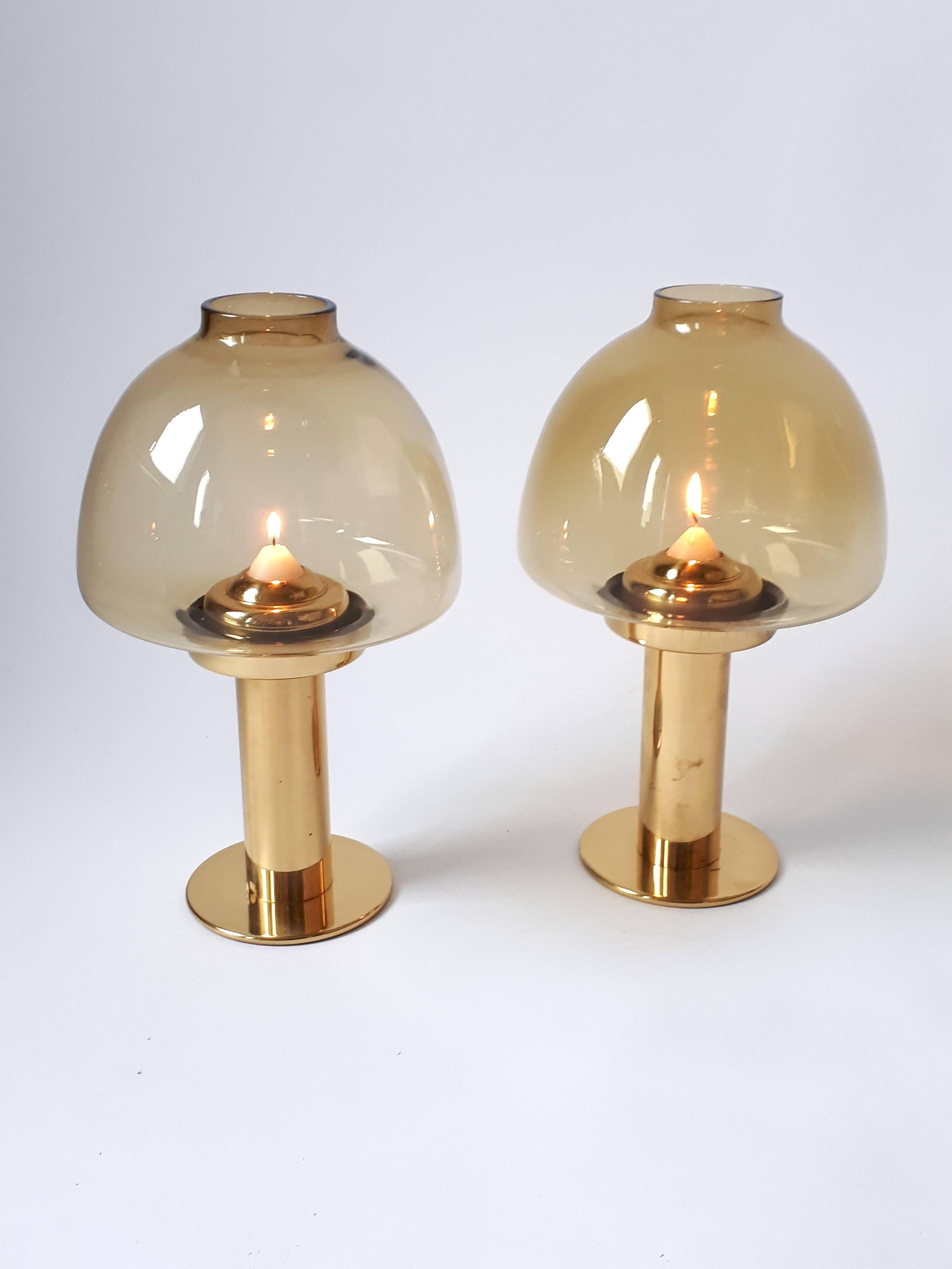 Elegant candleholder with mouth blowed bronze smoked hurricane glass shade.

Brass base with a spring mechanism that push up the candle while it burns.

Measures: 13. 5 inches high.