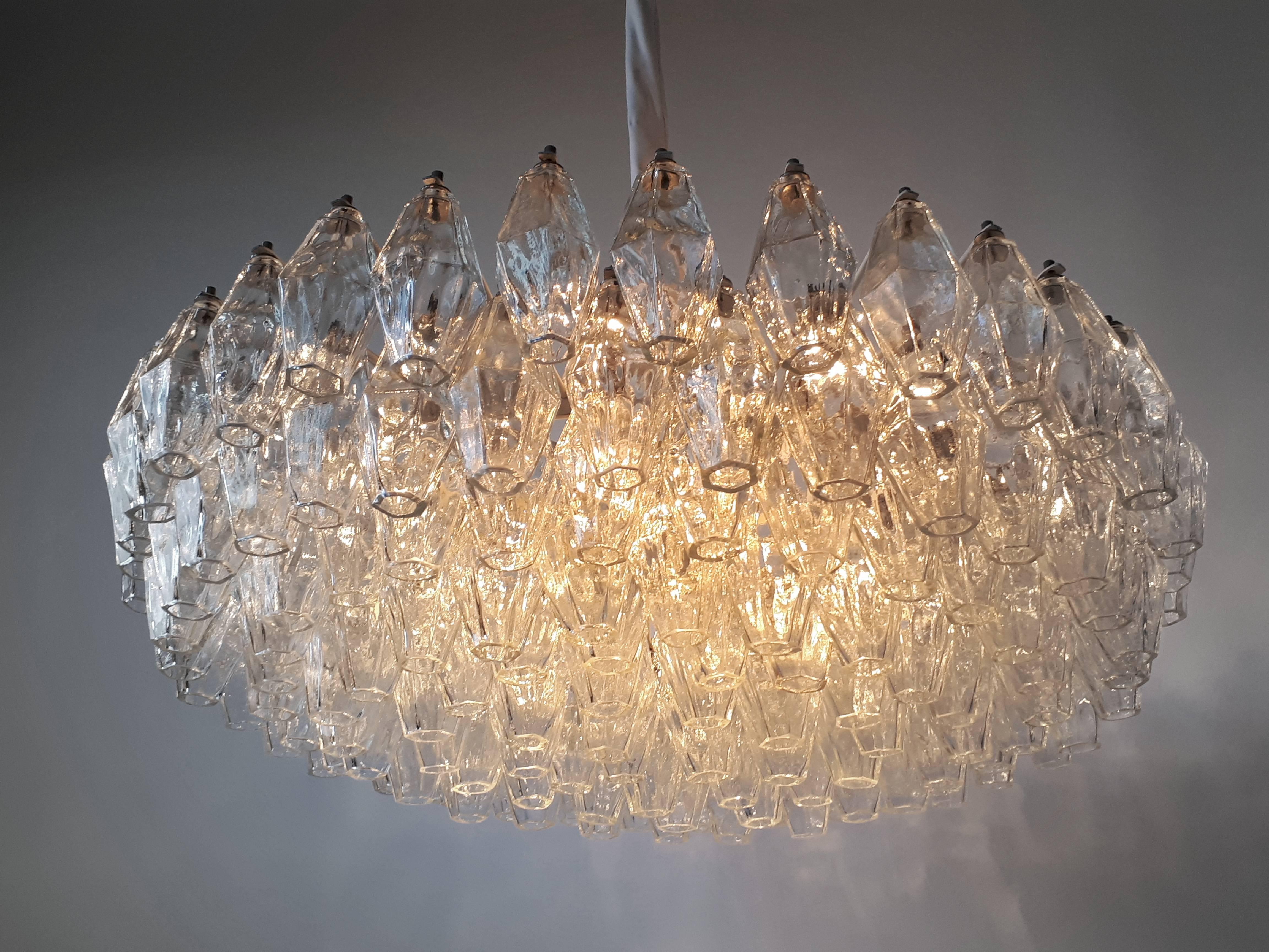 Large elegant chandelier made of individual multifaceted mouth blown glass pieces (poliedre).

Contains 11 E13 candelabra size light bulbs rated at 60 watts maximum. 

Designed by Carlo Scarpa.

Frame is all hand assembled and welded.

On each