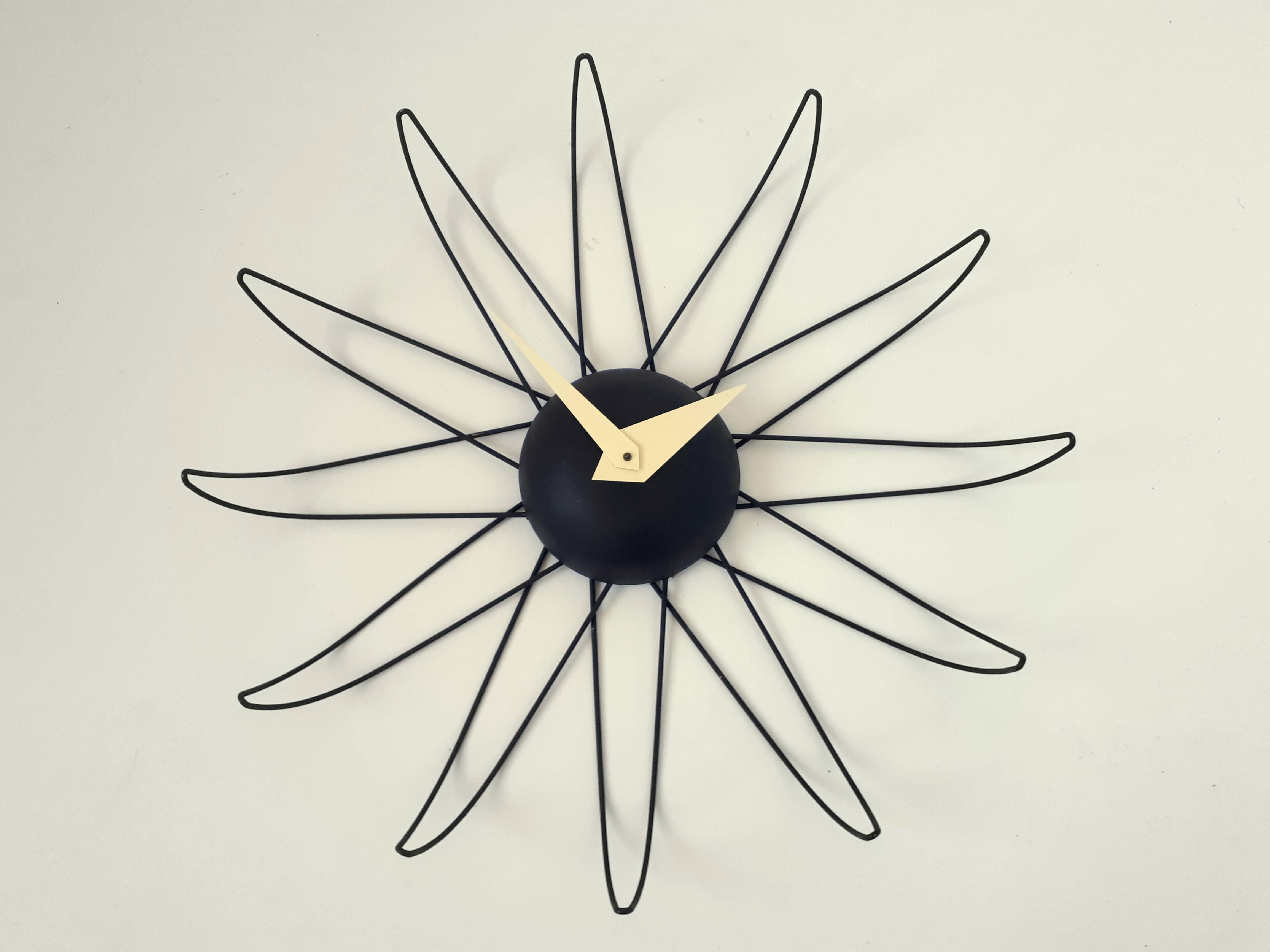 Frederick Weinberg clock made of steel wire, enameled in a flat black finish.

Original, functional electric motor by Lanshire. 

Original cord and plug. 

Measures: 24.5 in. wide by 4 in. deep.