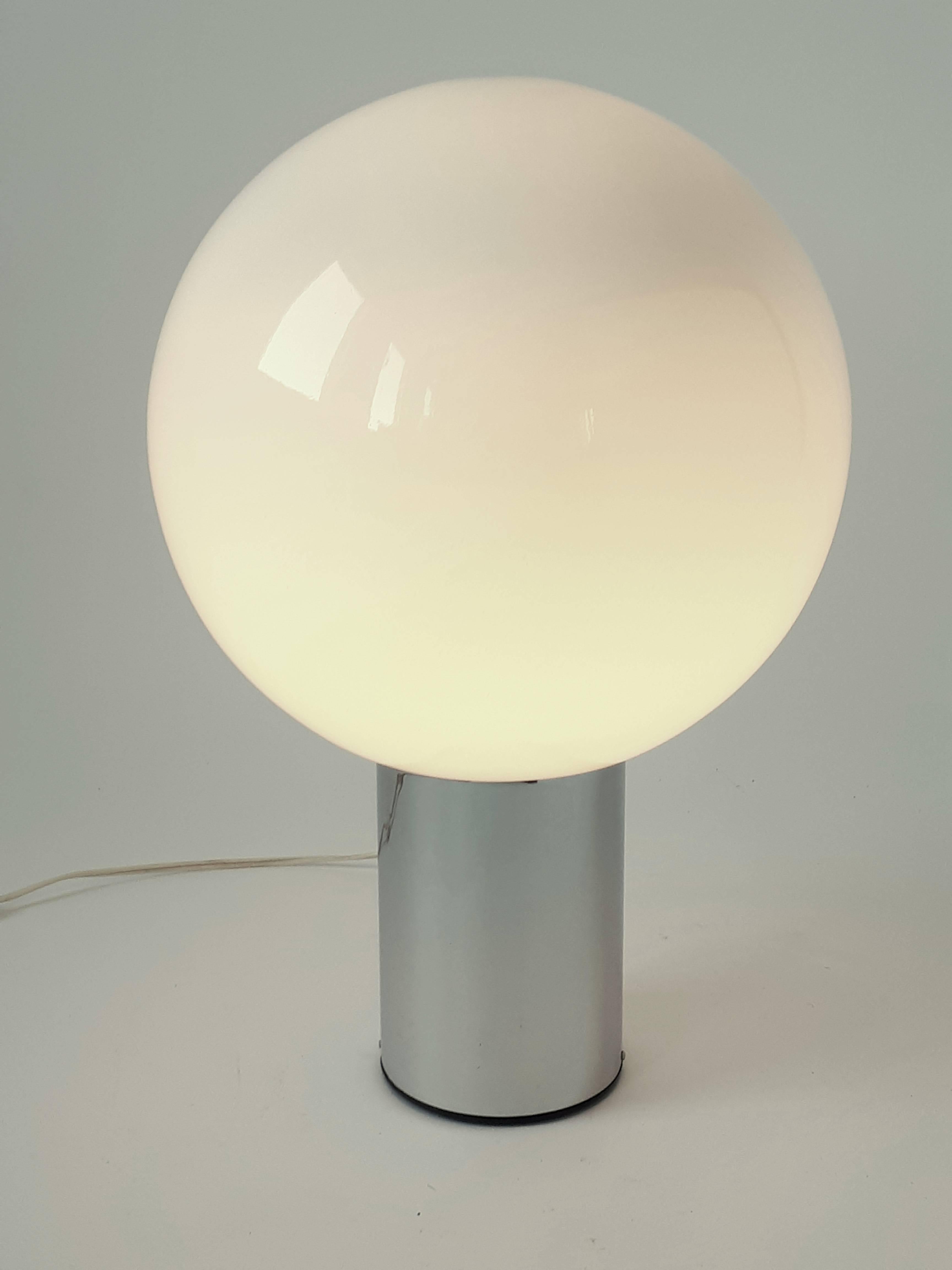 Large minimalist modern table lamp .

Thick opale glass eyeball sitting on a chrome base . 

Measures 11 inches wide .  

Bold with a presence . 

Switch on original cord . 

E26 regular size socket rated at 60 watts maximum.
  