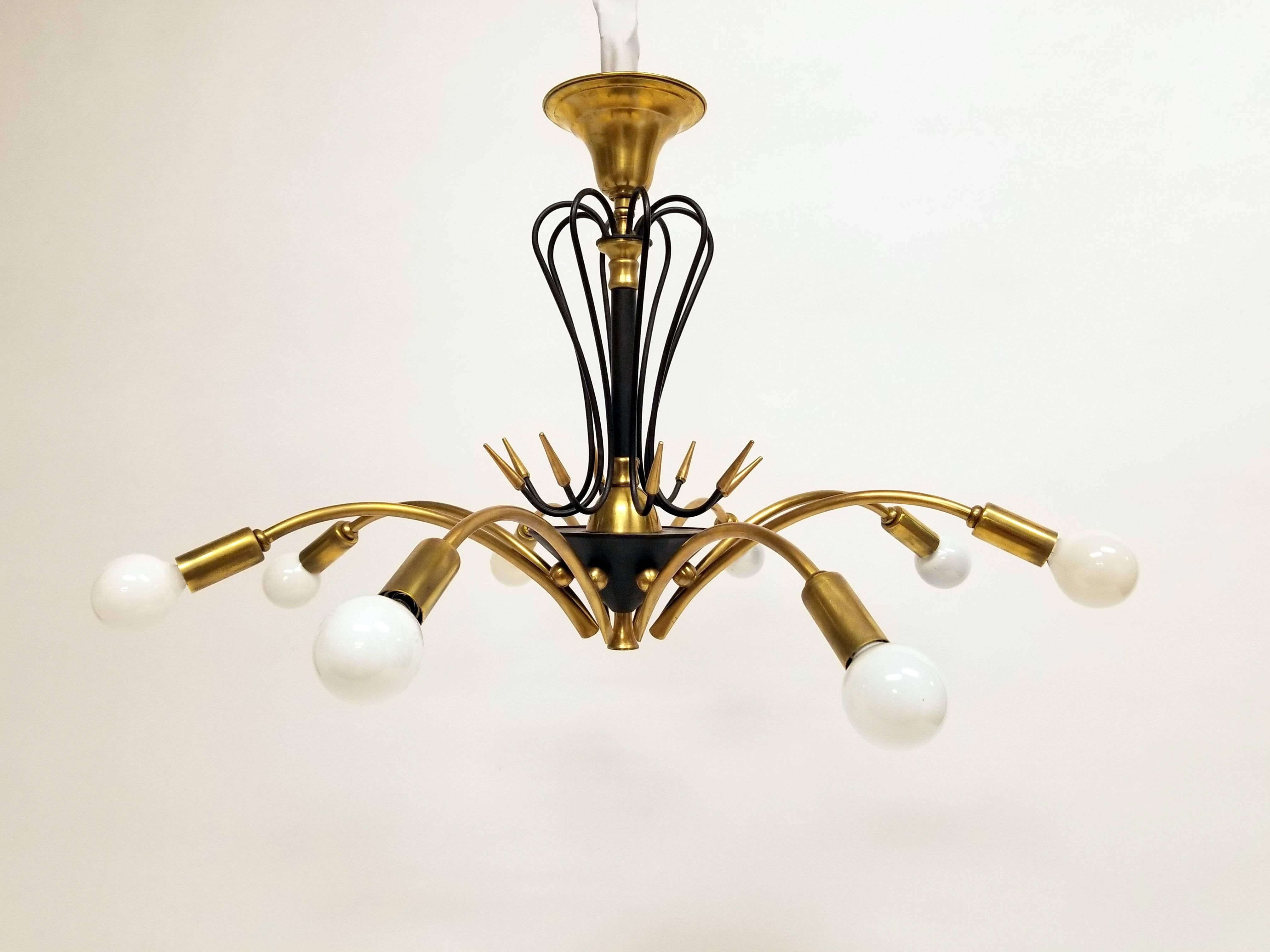 Italian brass and enameled steel chandelier with a bold punkish touch !

Eight candelabra E12 size socket.