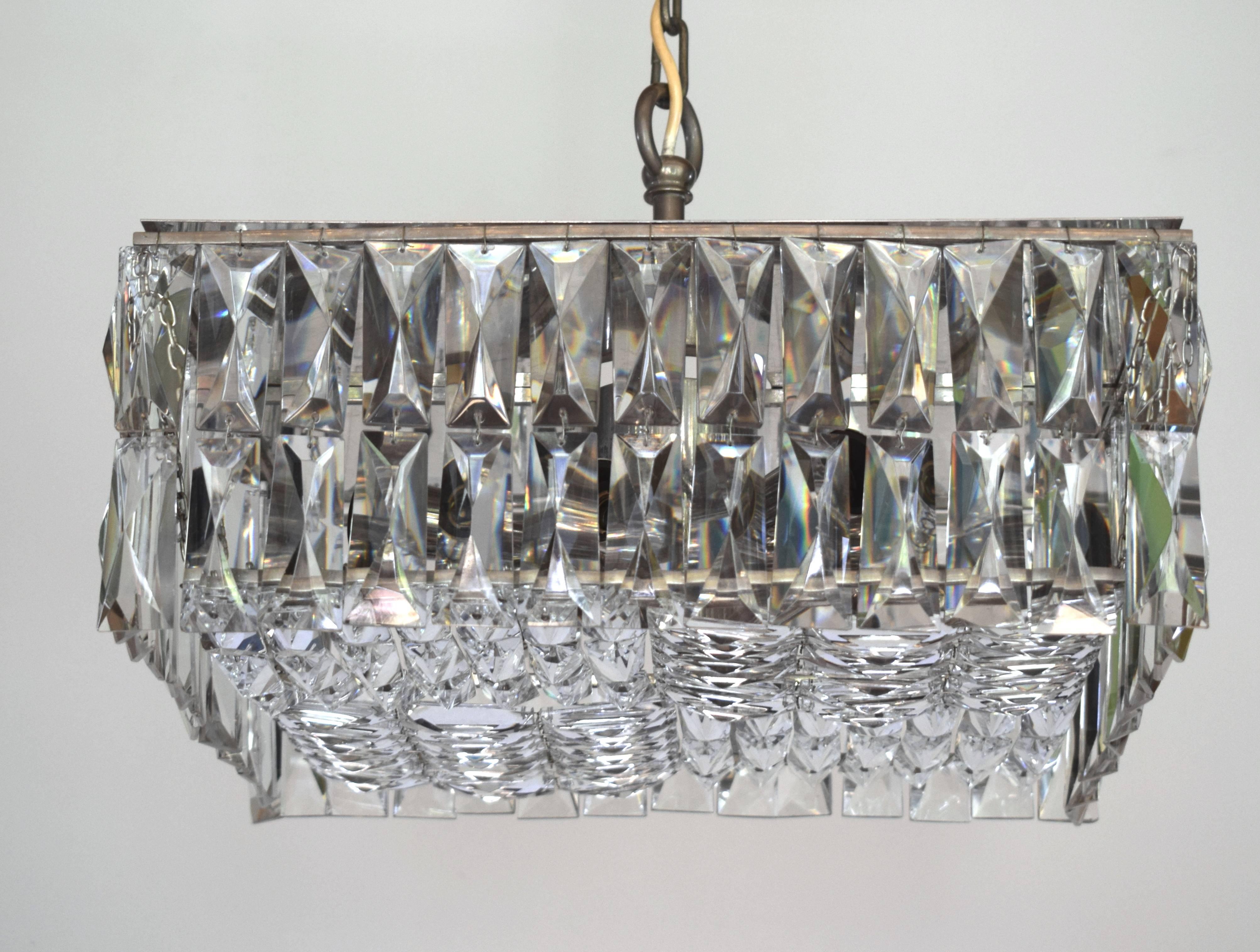 Steel construction with eight lights and with 40 X 40cm (15.74 X 15.74 in) hand-cut crystal elements from the 1960s made by Bakalowits & Sohne.
Very rare!