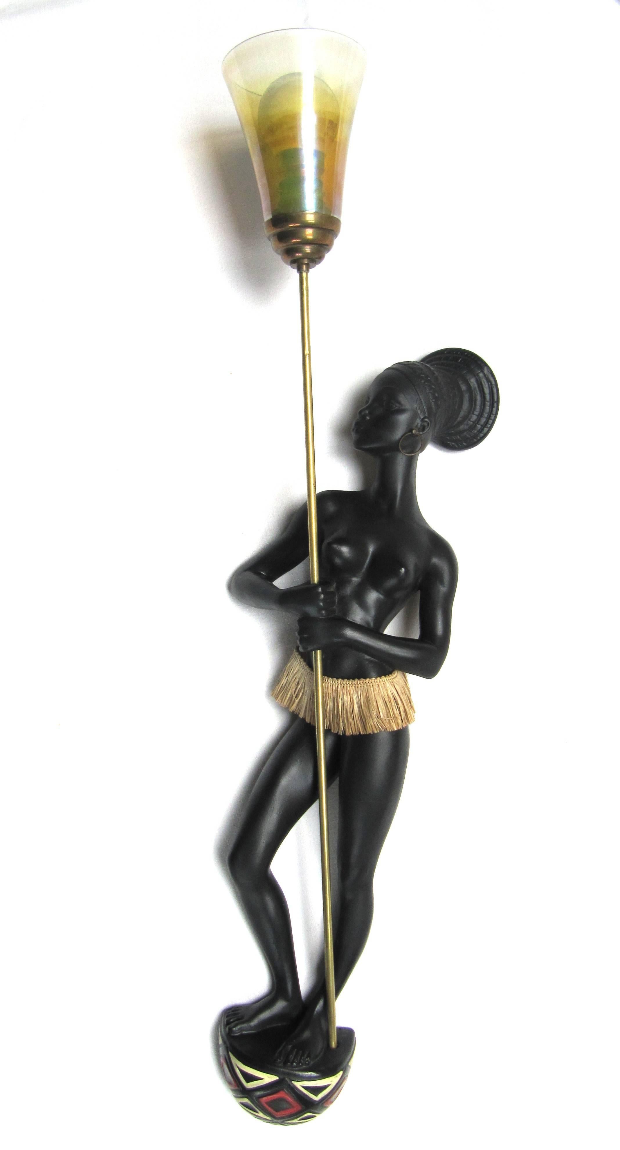 Leopold Anzengruber (signed Andre Carli); Vienna, Austria,
circa 1955.
Rare large pair of 1950s ceramic sconces, Nubian subject, signed André Carli (Leopold Anzengruber), in perfect original condition. Figures are in ceramic enhanced by raffia