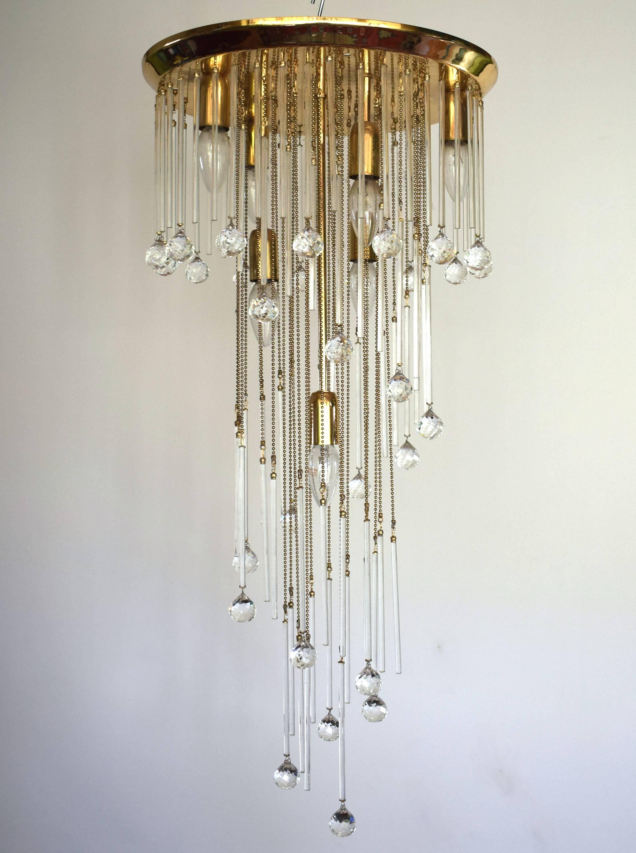 Stunning large chandelier by Ernst Palme (Palwa), Germany from the 1970s: flush mount fixture with crystal balls and thin glass bars which hang on brass chains at varying heights building a spiral.
Fixture is made gold plated brass (in very good