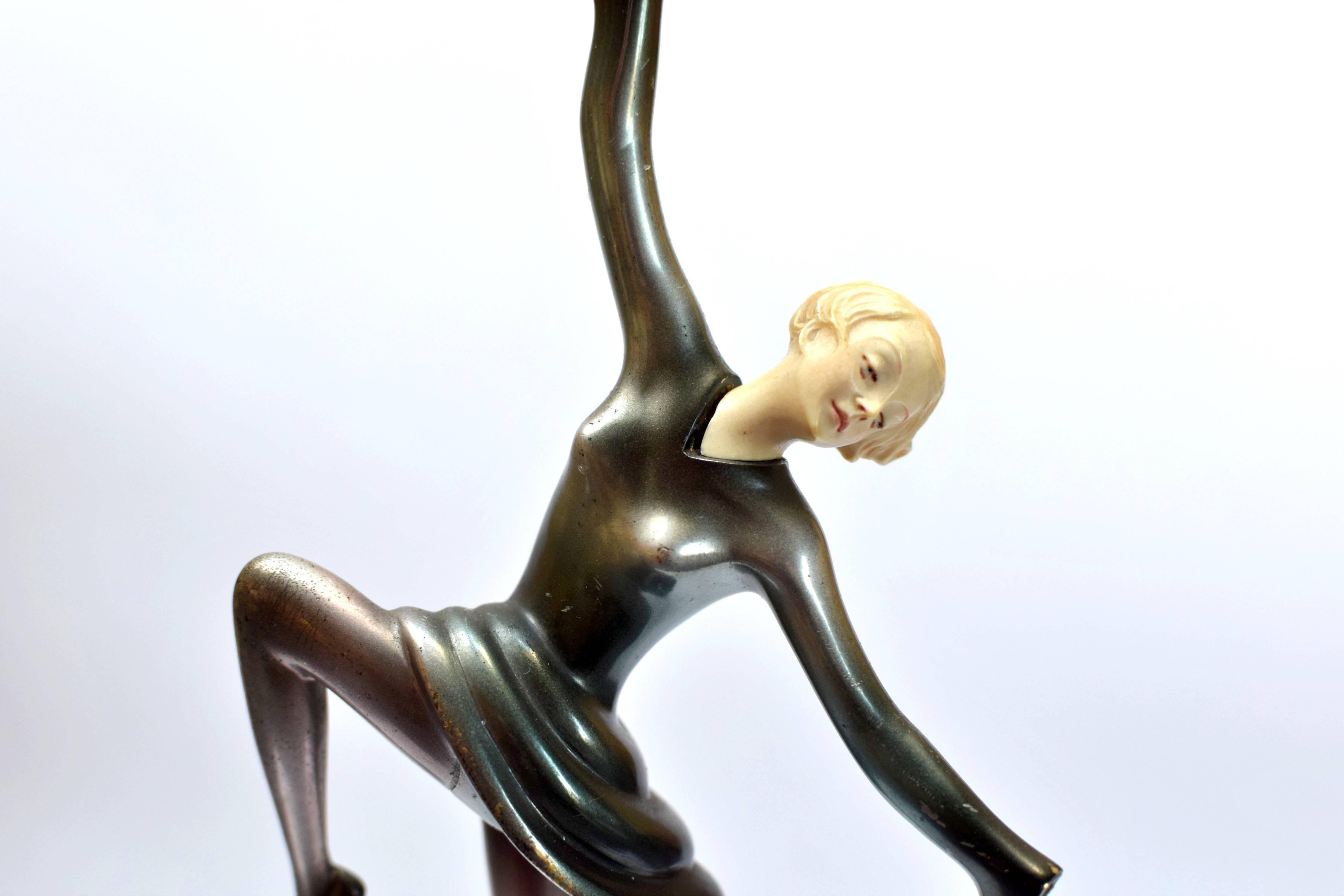A superb bronze and ivorine sculpture with a gold, silver and enameled cold-painted finish, mounted on an onyx base.
Height 23,5 cm.
Signed Lorenzl.

Both hands are missing!