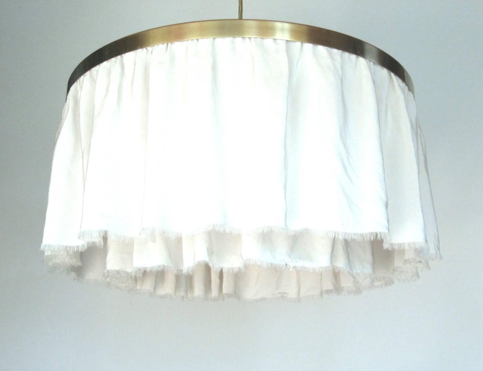 Designed by Adolf Loos and produced in Austria during the 1960s. Made from brushed brass and pleated silk with a plucked hem, features three bulbs. The height of the lamp is adjusted with a bullet train from 80 cm to 140 cm. This model was used by