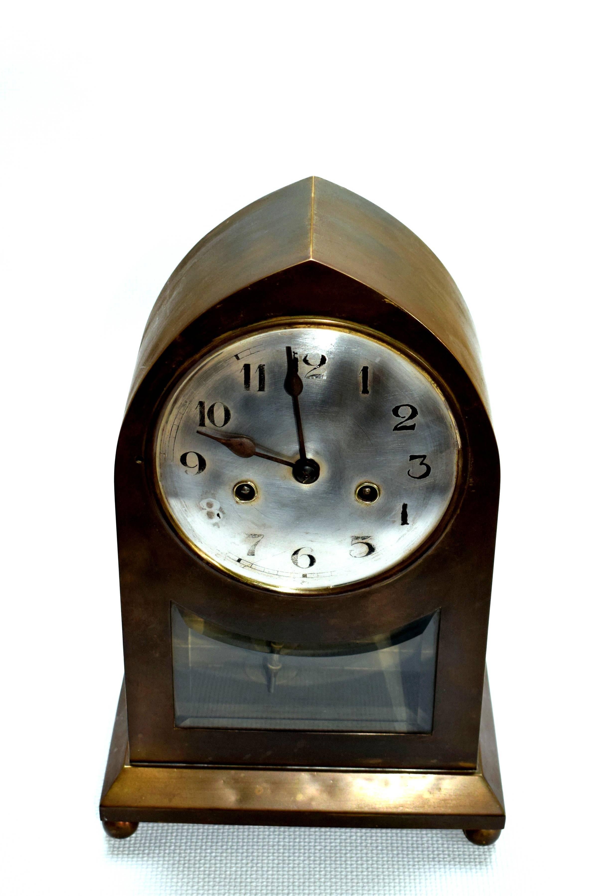 Large table clock in the style of the Wiener Werkstätte. Case made from brass. Silver plated face (rubbered). 
Art Nouveau clock movement.
Coil gong every half an hour. Key to wind up the clock is provided.
Original working condition.