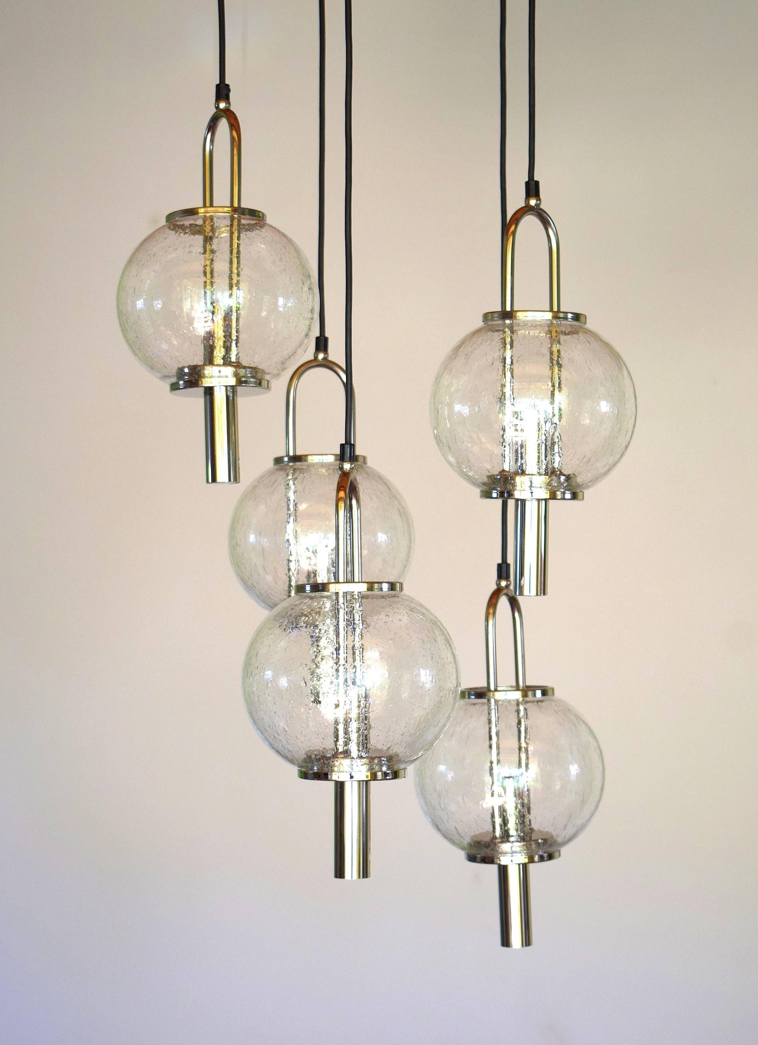 This stunning Mid-Century Modernist chandelier by Kalmar features five Murano glass ball shades descending from a star form base with chrome detailing.
Very heavy and massive.
Very good condition.