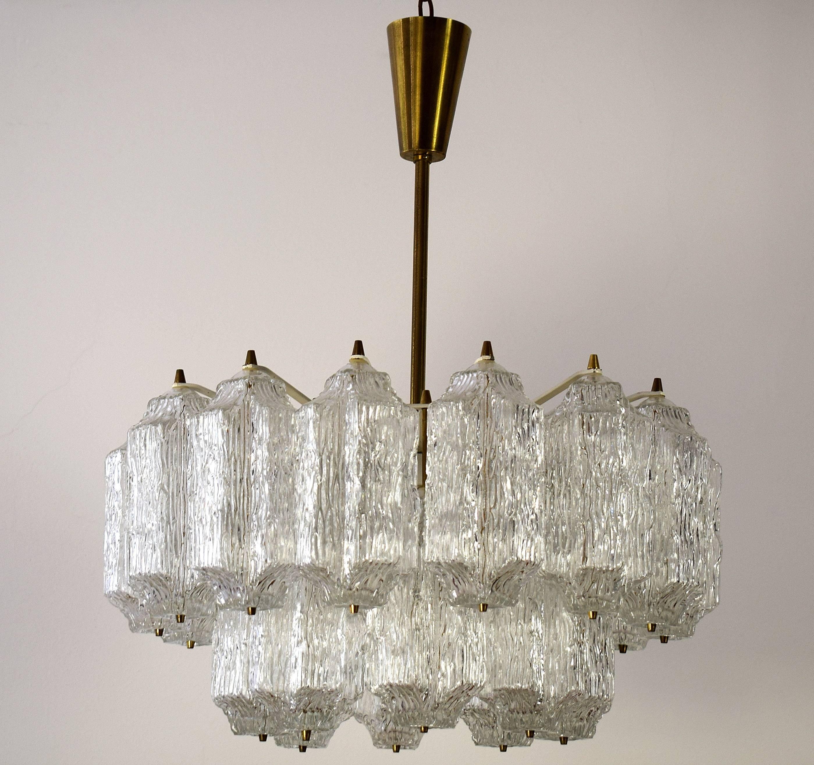 A square and large light fixture by J.T. Kalmar, Austria, manufactured in midcentury, (end of 1960s and beginning of 1970s). 

The fixture is made of white lacquered brass frame with 12 small base bulbs which are covered with 22 ice glasses.