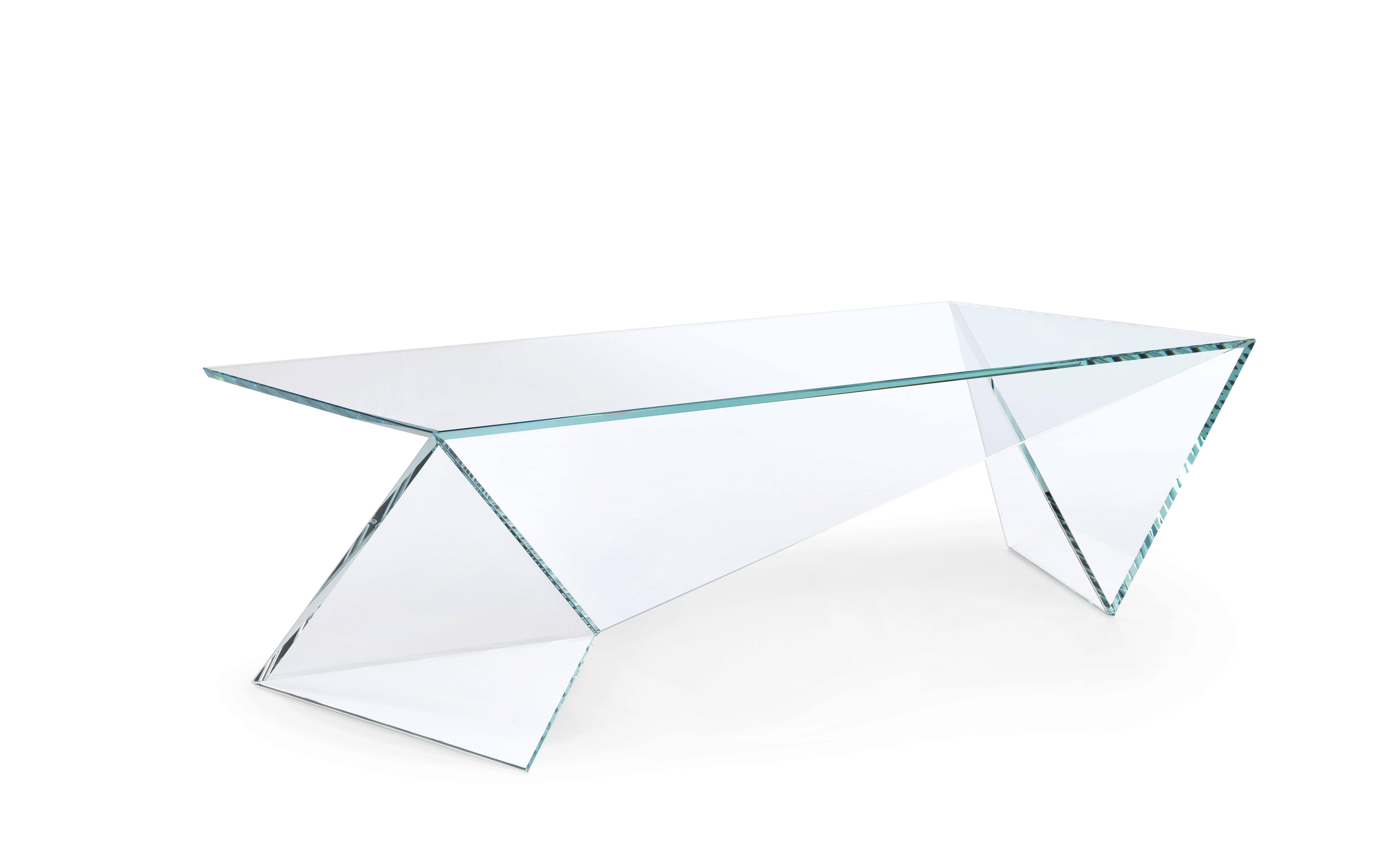 The coffee table 'Origami' is made of extra-clear crystal glass. Each sheet of extra-clear crystal glass is cut and ground with extreme precision, then the sheets are assembled by hand, having to fit together perfectly, the gluing operation requires