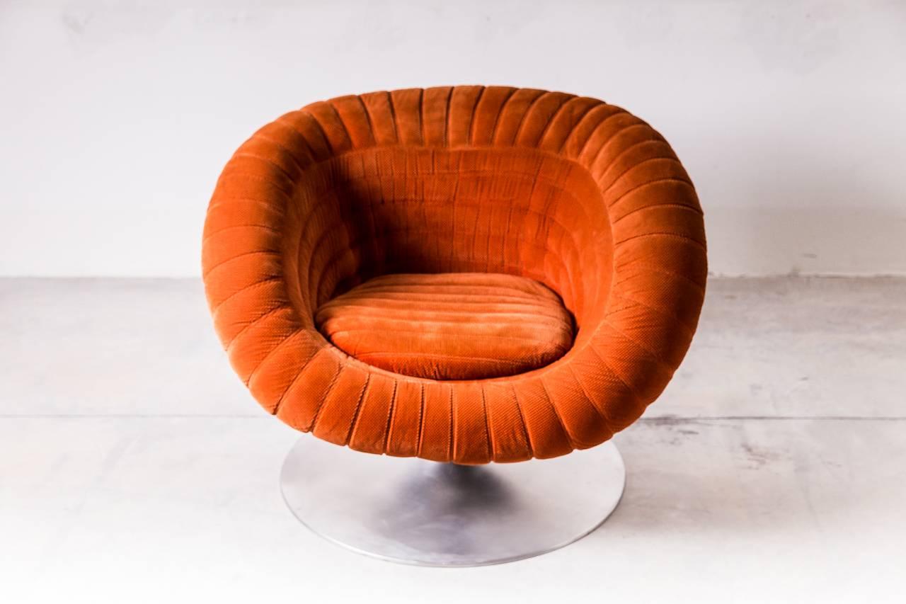 Rare Mid-Century egg style chair with over sized polished aluminium tulip base. The seat is upholstered in its original fabric which is intricately worked and stitched to creates a truly unique chair.
   