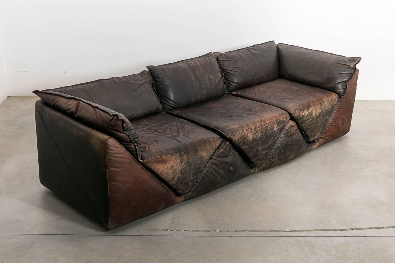 Original and very rare couch by for Sormani Italy. The pillows are cut in a triangular shape and made of leather which has developed a beautiful patina. The original makers mark is on the underside of the pillows. See publication in Domus Magazine,