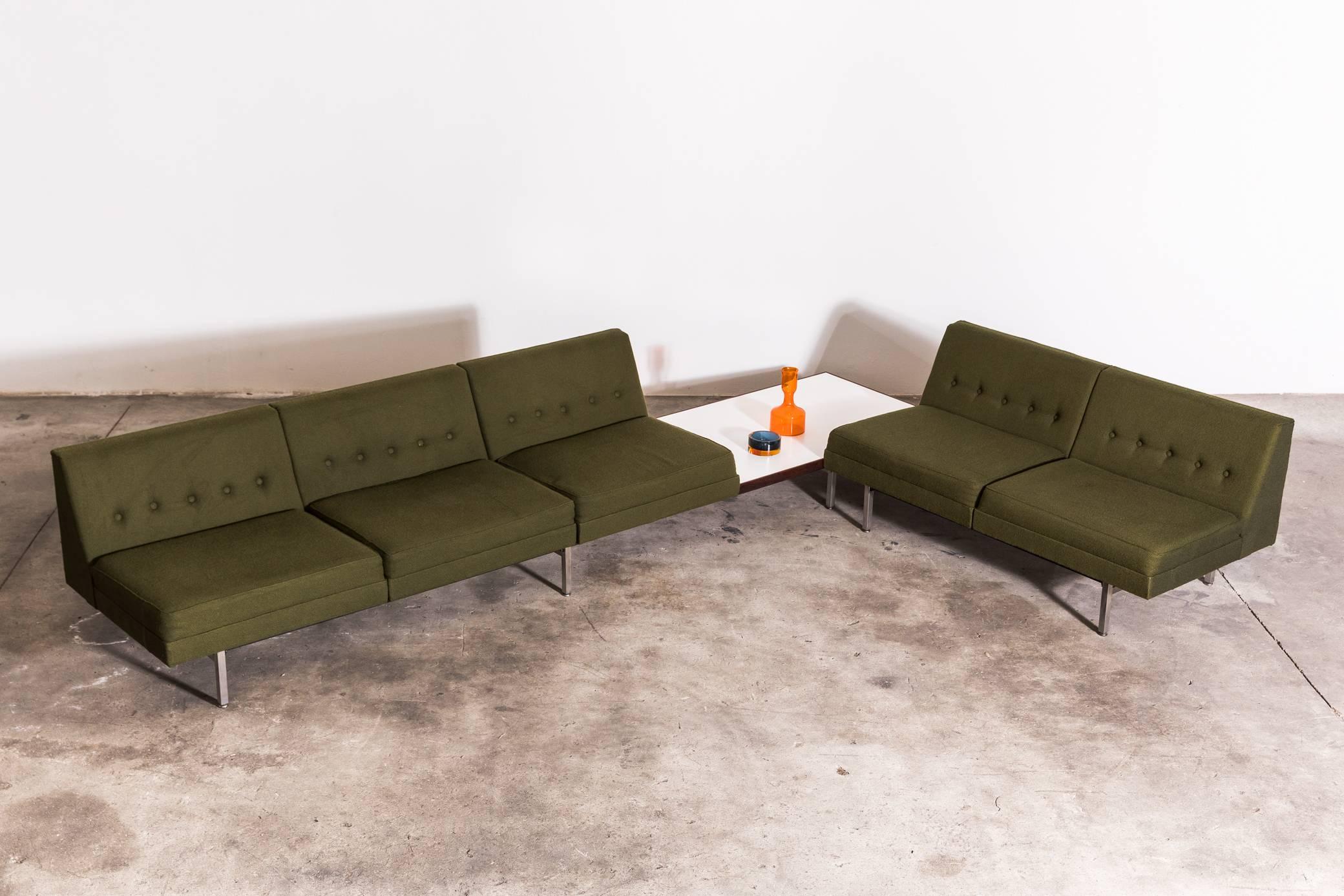 This exceptional modular piece by George Nelson for Herman Miller was produced in 1968. A sectional sofa created by combining two sofas, features three armless seats, a formica table, and a two-seat sofa. They can be arranged in an order that suits