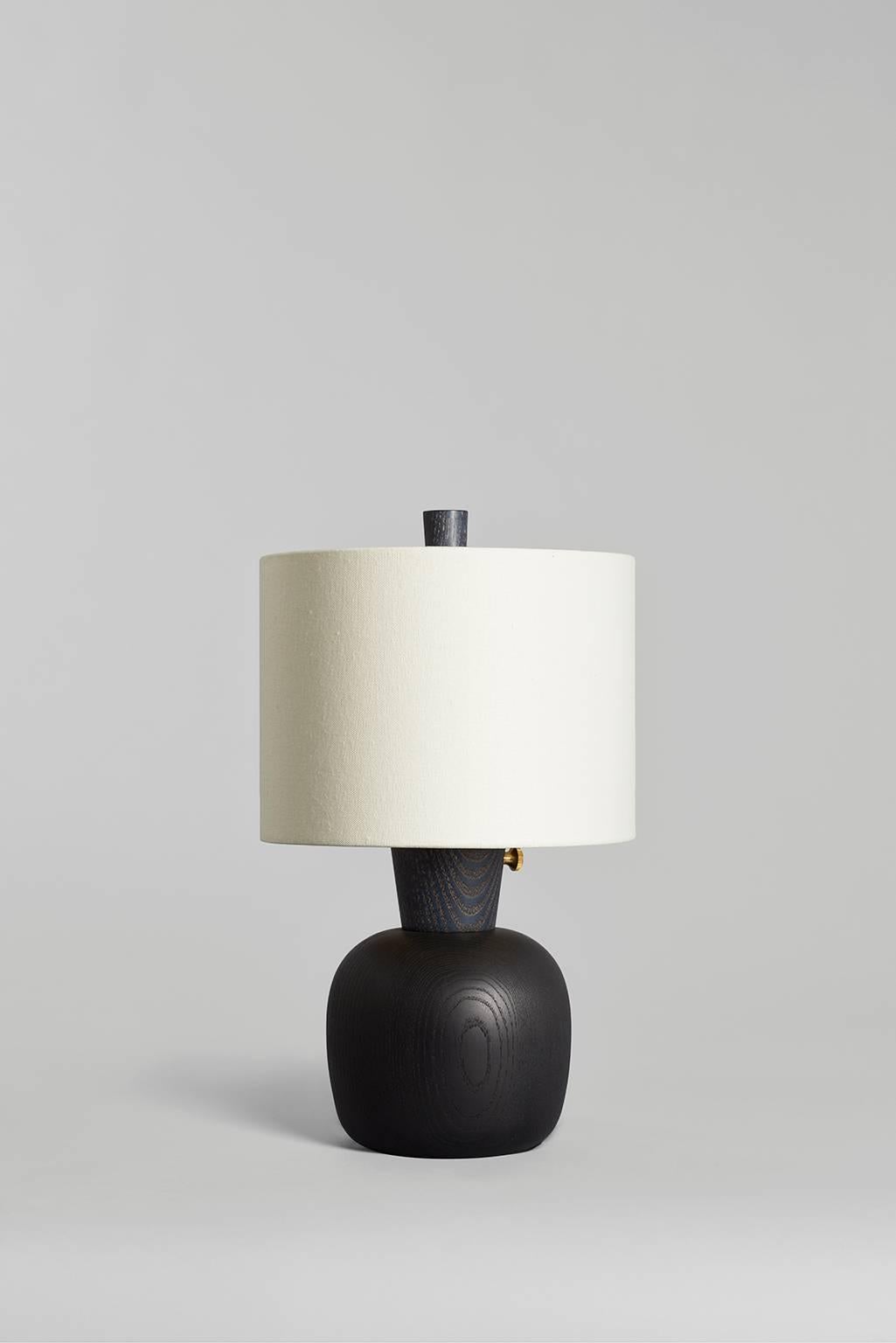 Small with a big presence, the Marty inhabits intimate spaces, scaled for the bedside or tabletop. This model has a matte black surface inspired by satin black hot rod paint jobs. Turned, maple base with matte black finish and navy blue neck and
