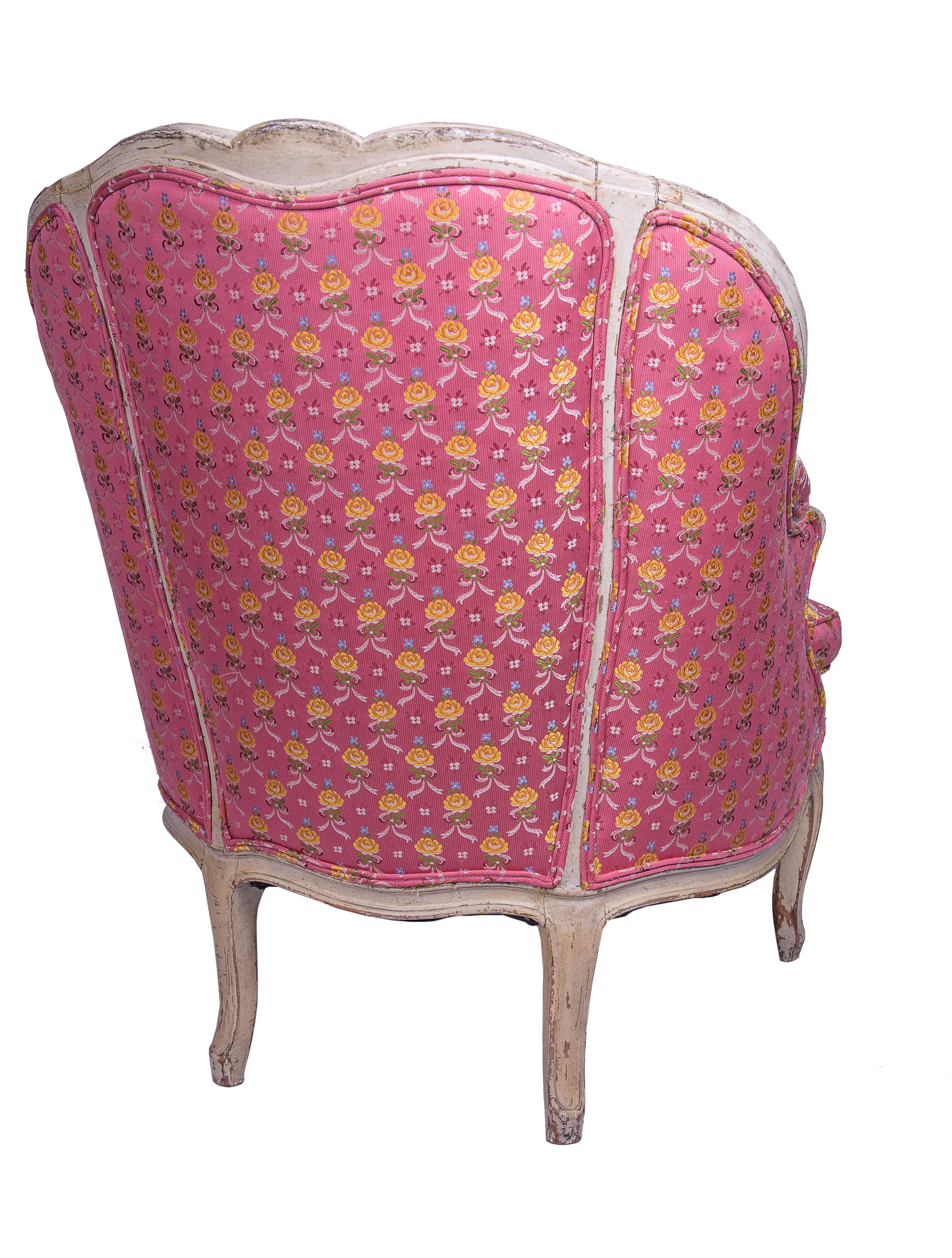19th century French Louis XV style bergere is carved and cream painted, upholstered with loose cushion.