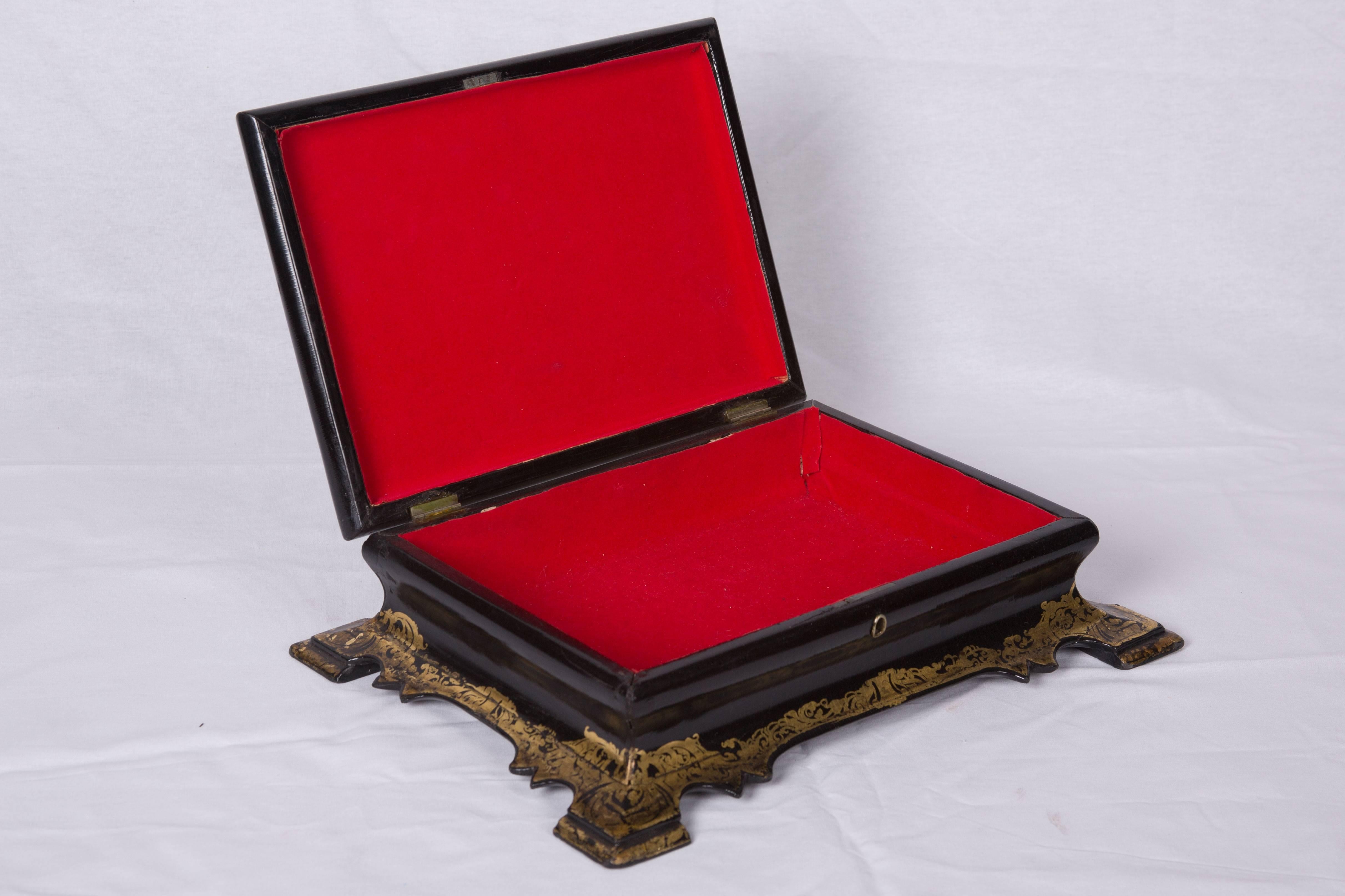 Pictured is a Victorian mid-19th century papier mâché stationary box with classic mother-of-pearl and abalone inlaid designs as well as painted and gilt decoration. The hinged top with a molded edge opens to a later fabric lined storage area. Raised