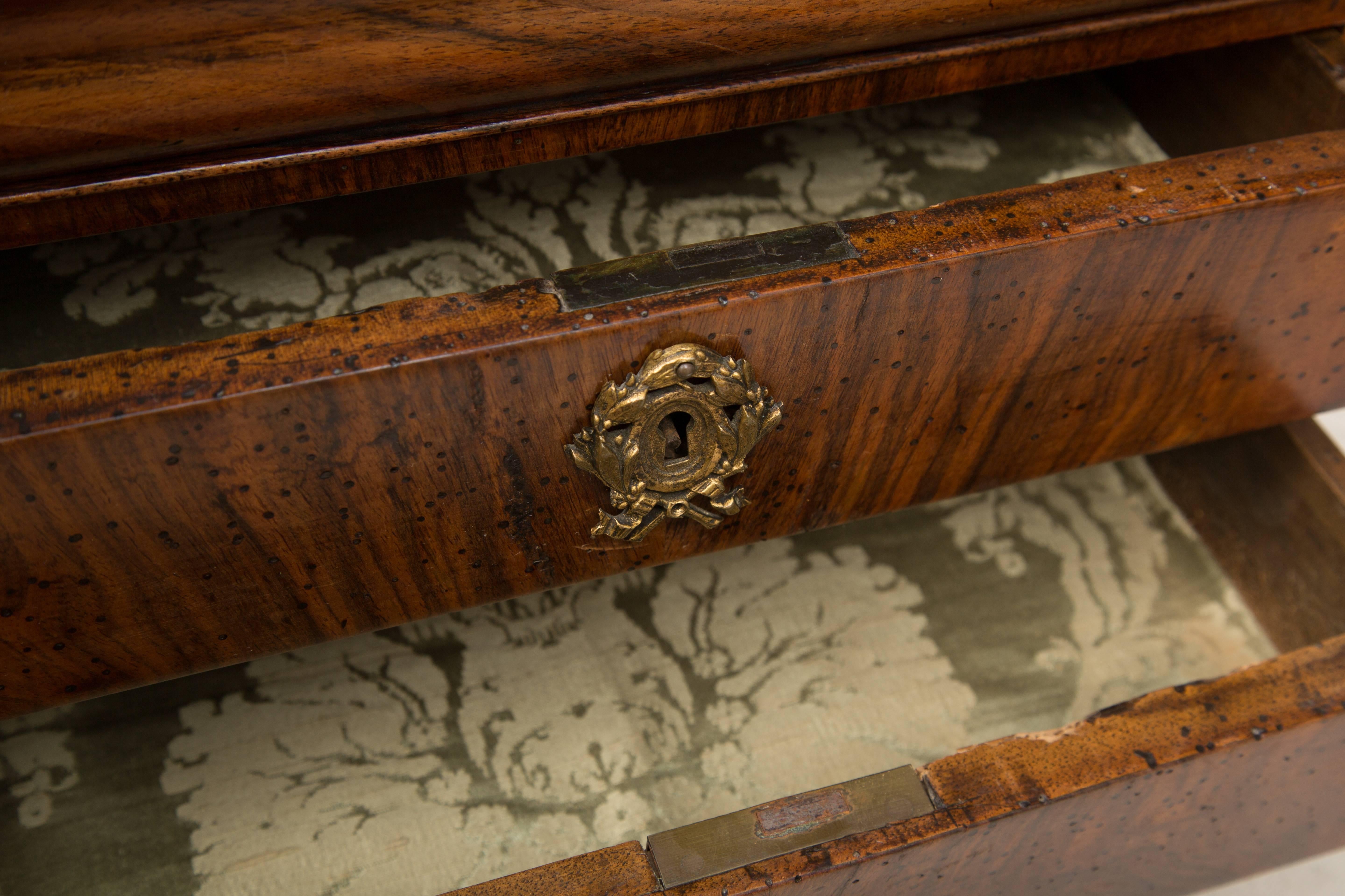 This French, Louis Philippe walnut speciman commode has a little more top above a frieze operating as a drawer over two long drawers and raised on shaped bracket feet, circa 1840.